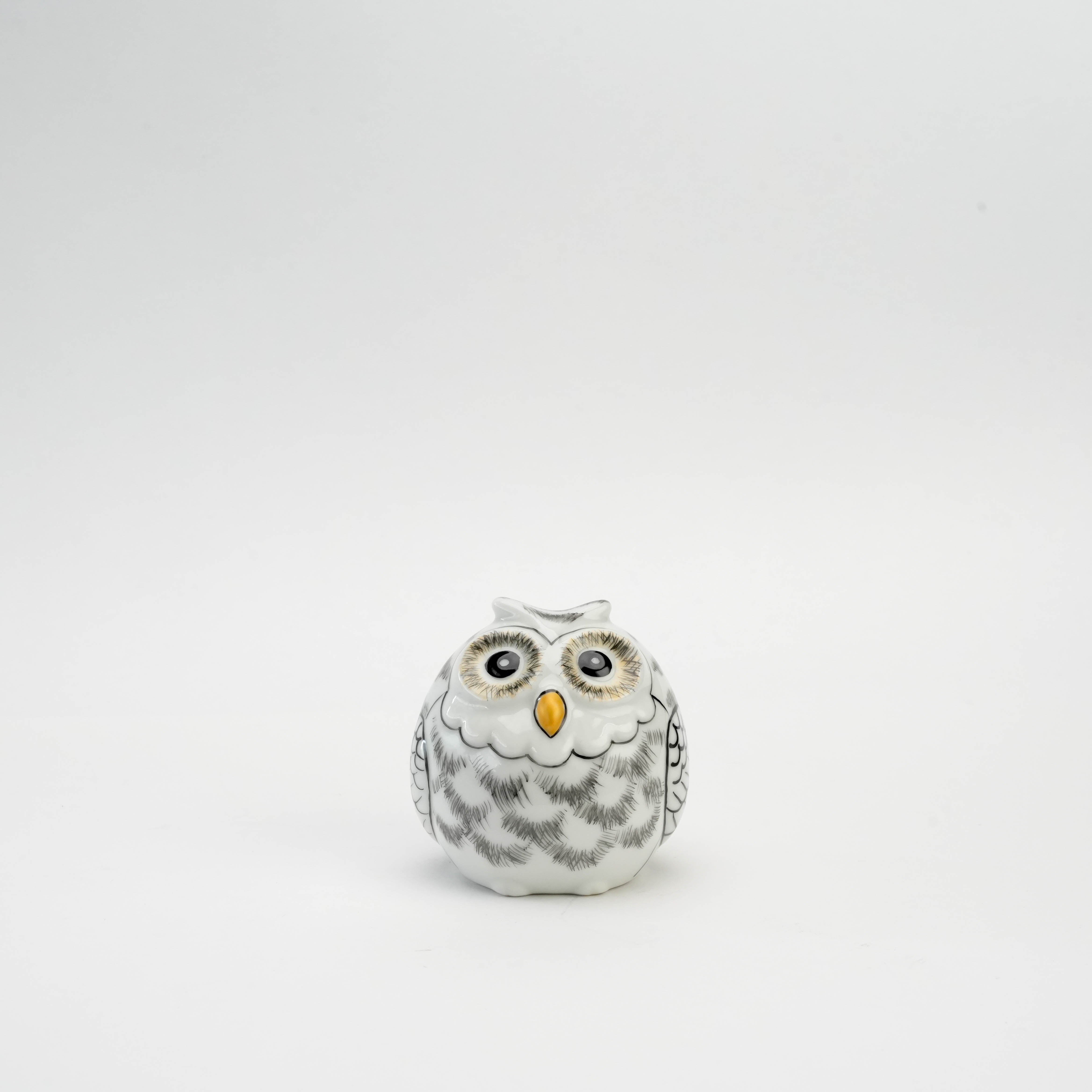 Kutani Owl Figurine in white porcelain with grey feather detailing and golden beak, symbolizing wisdom and protection for home decor.