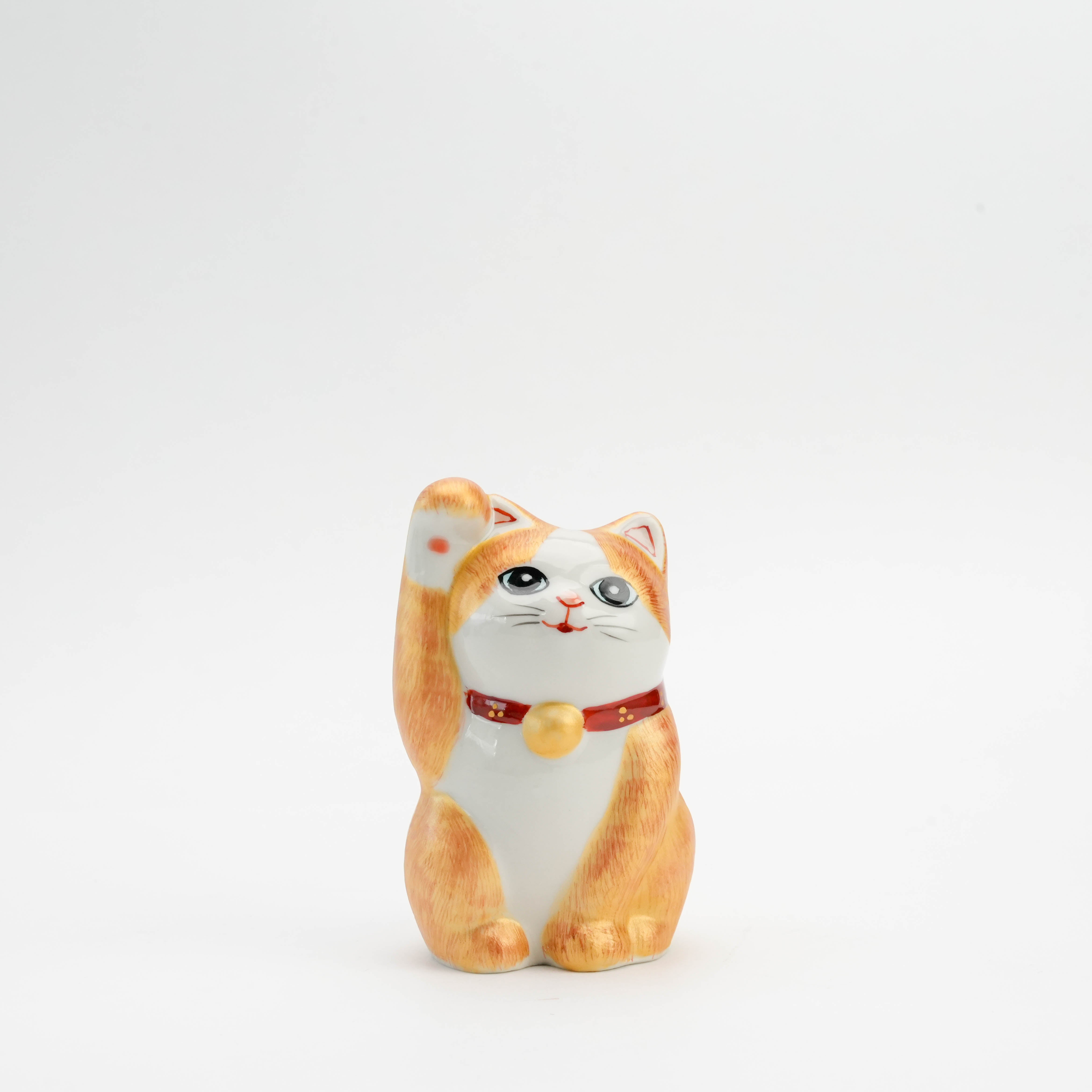 Kutani Ware Cat Ornament with gold accents and hand-painted orange fur, featuring a raised paw and red collar. Ideal for home decor or gifting.