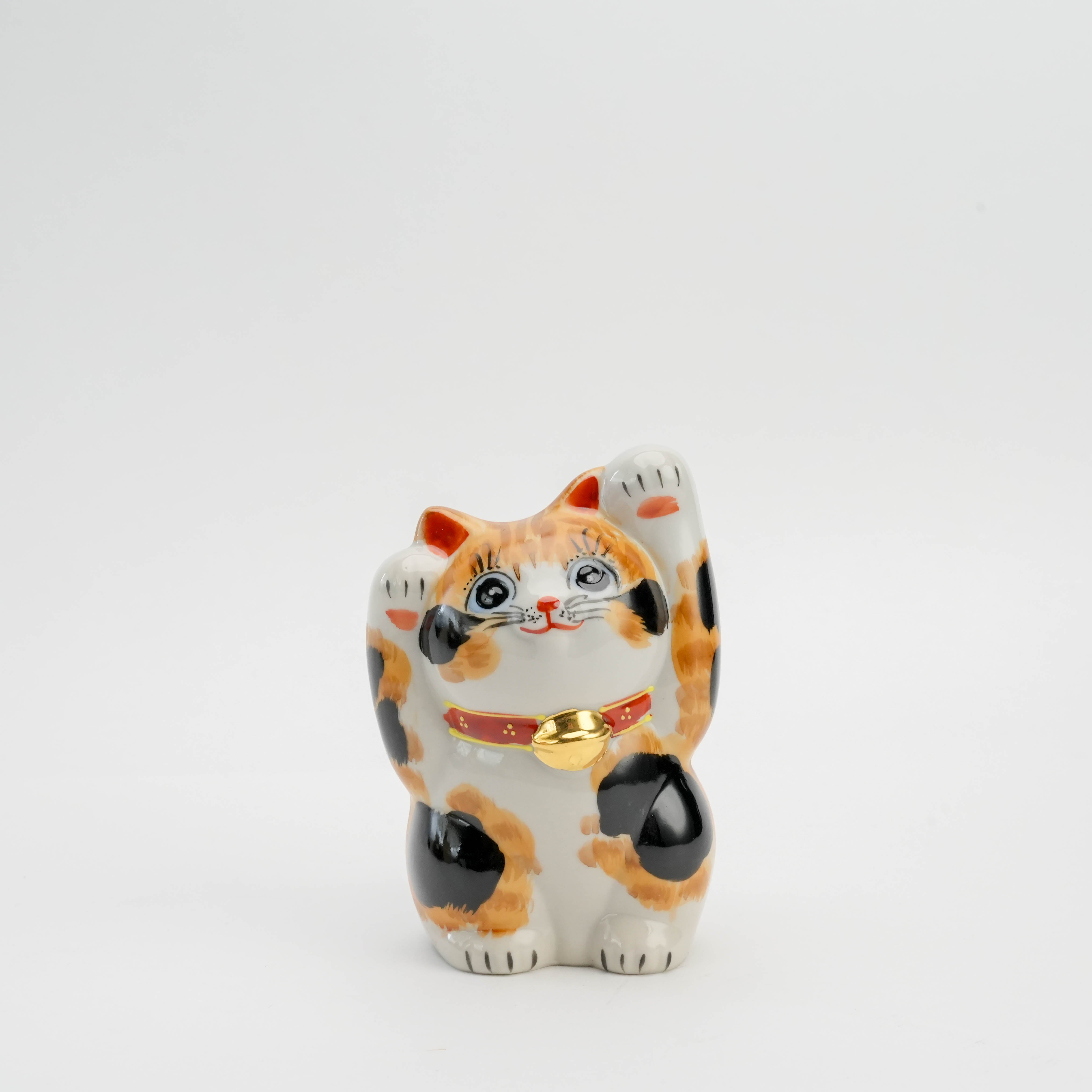 Kutani Ware Cat Ornament - Calico Maneki-neko with both paws raised, hand-painted in vibrant orange, black, and white for prosperity and charm.