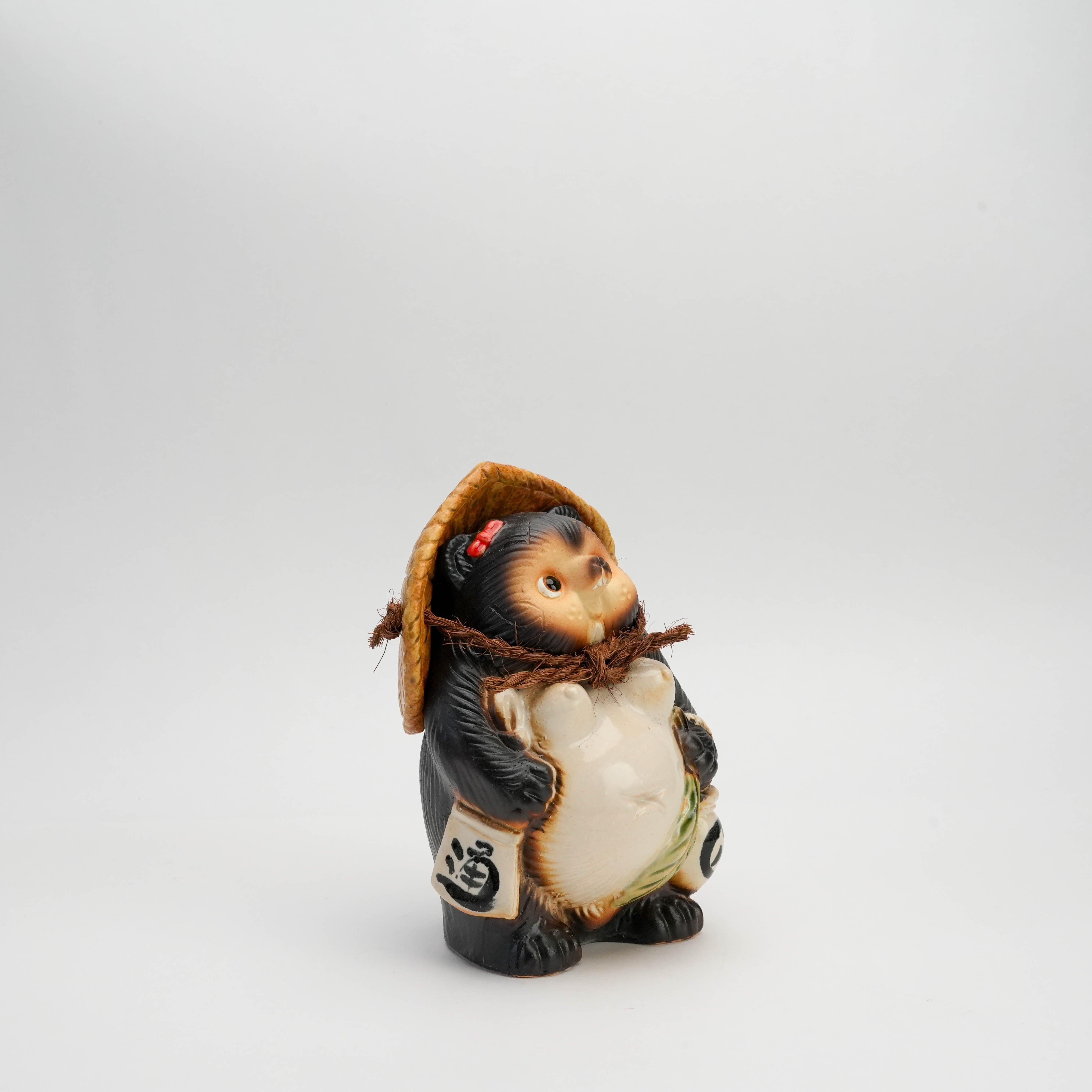 Side view of Shigaraki Ware Female Lucky Tanuki Ornament showing detailed craftsmanship and traditional Japanese attire. Ideal home decor figurine.
