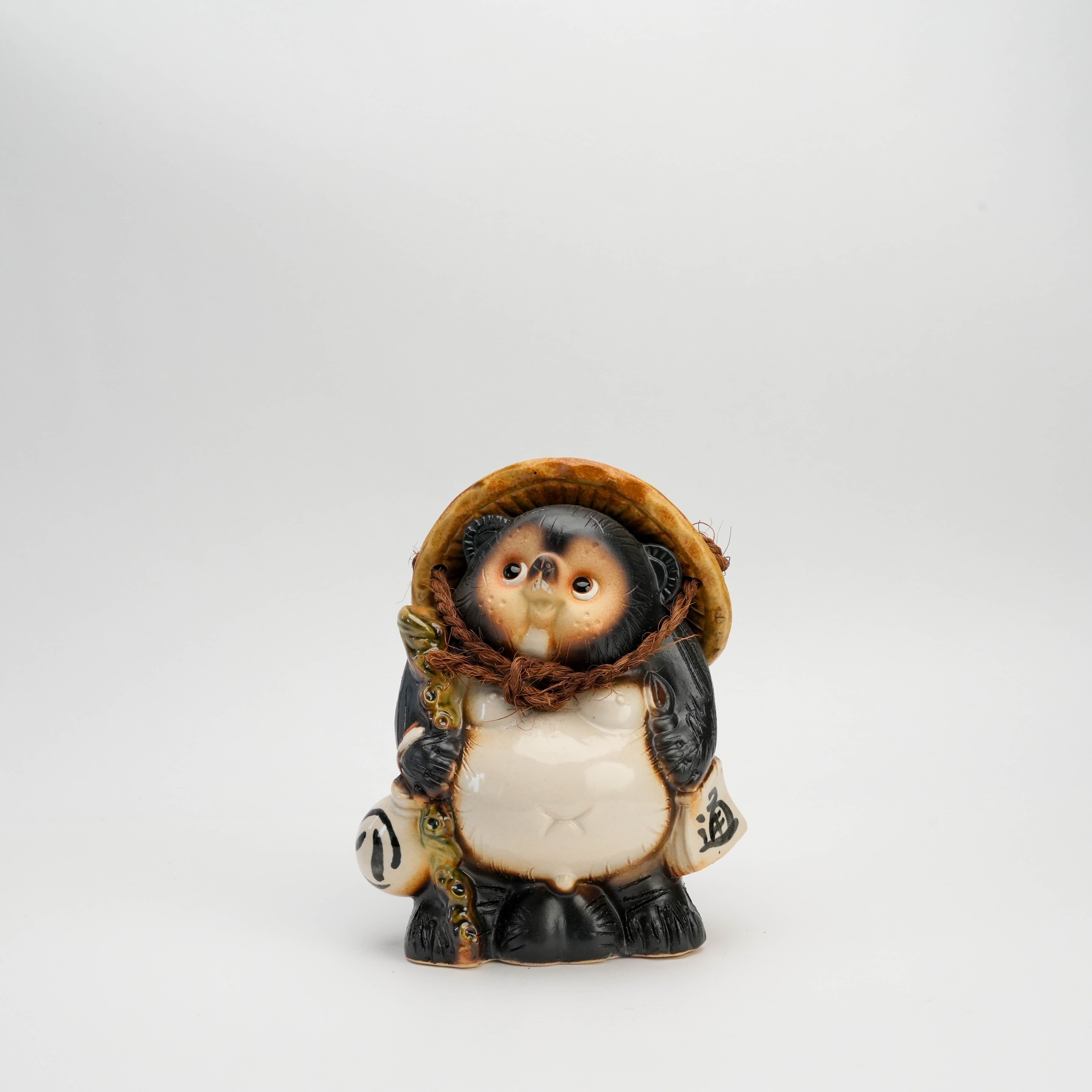 Tanuki Raccoon Ornament - Shigaraki Ware | Lucky Charm figurine featuring a handcrafted male tanuki with straw hat and sake bottle, front view.