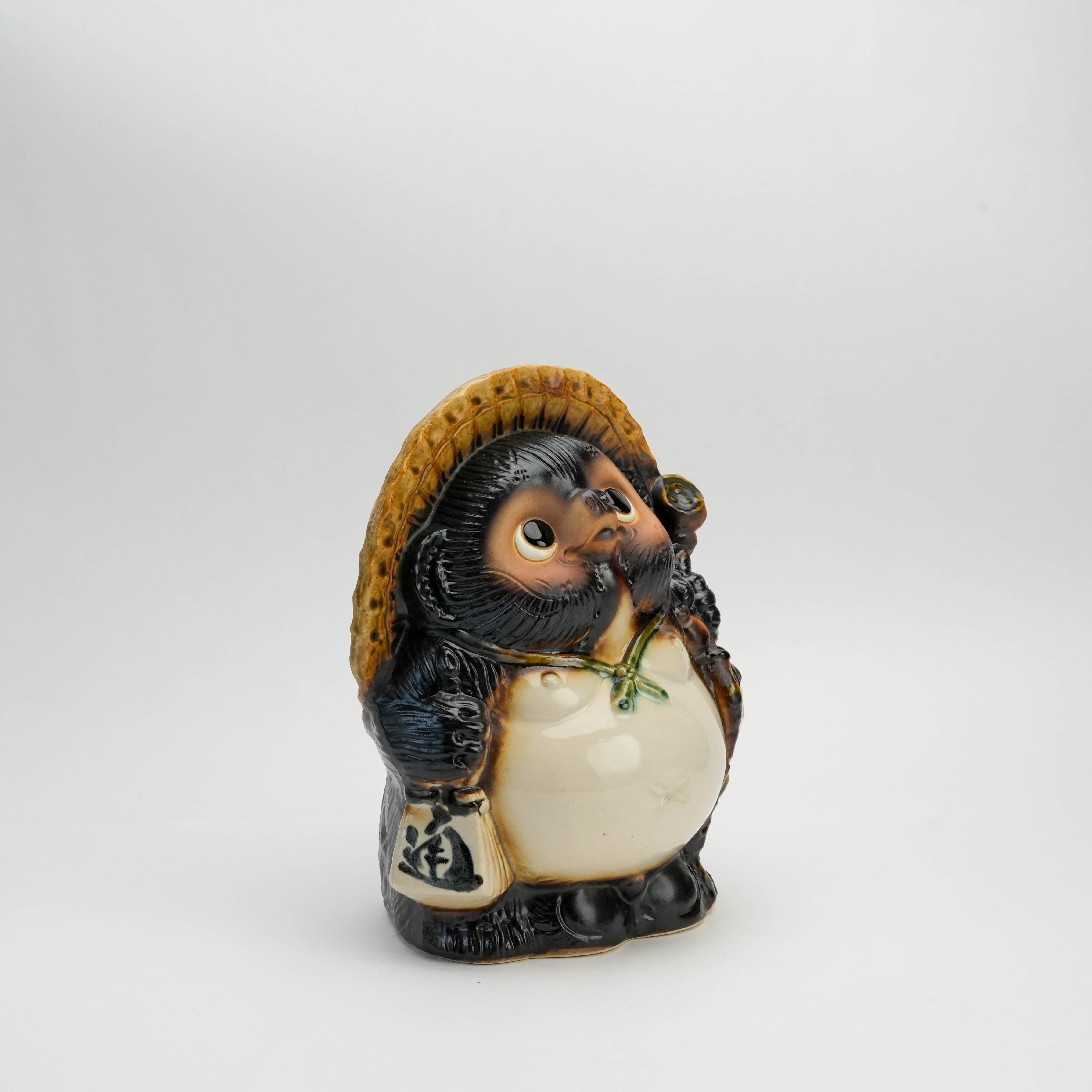 Angled left view of Fukufuku Lucky Tanuki Raccoon Ornament showing detailed ceramic craftsmanship and traditional Japanese design.