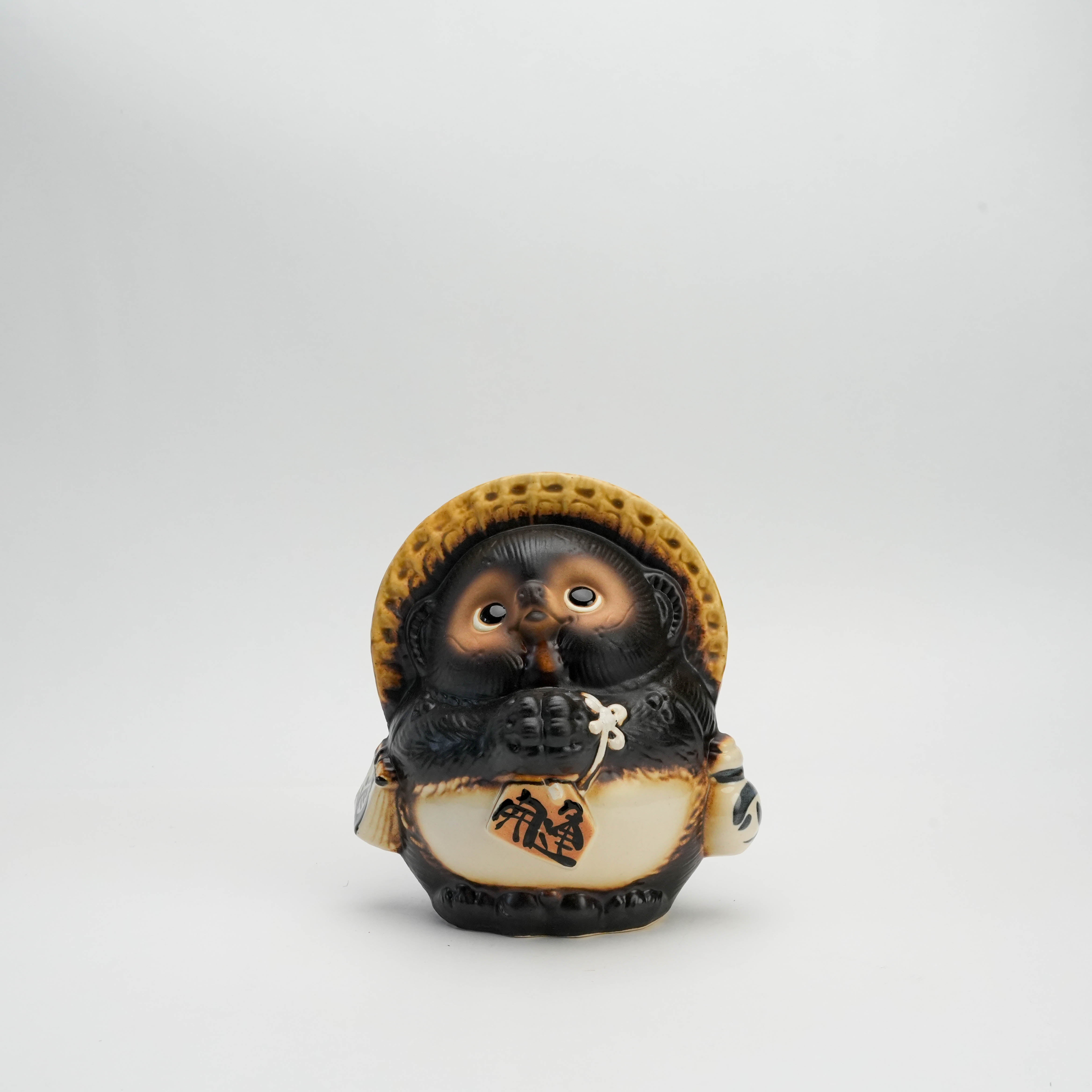 Shigaraki Tanuki - Lucky Raccoon Ornament with straw hat and coin pouch, symbolizing good fortune and prosperity in Japanese decor.