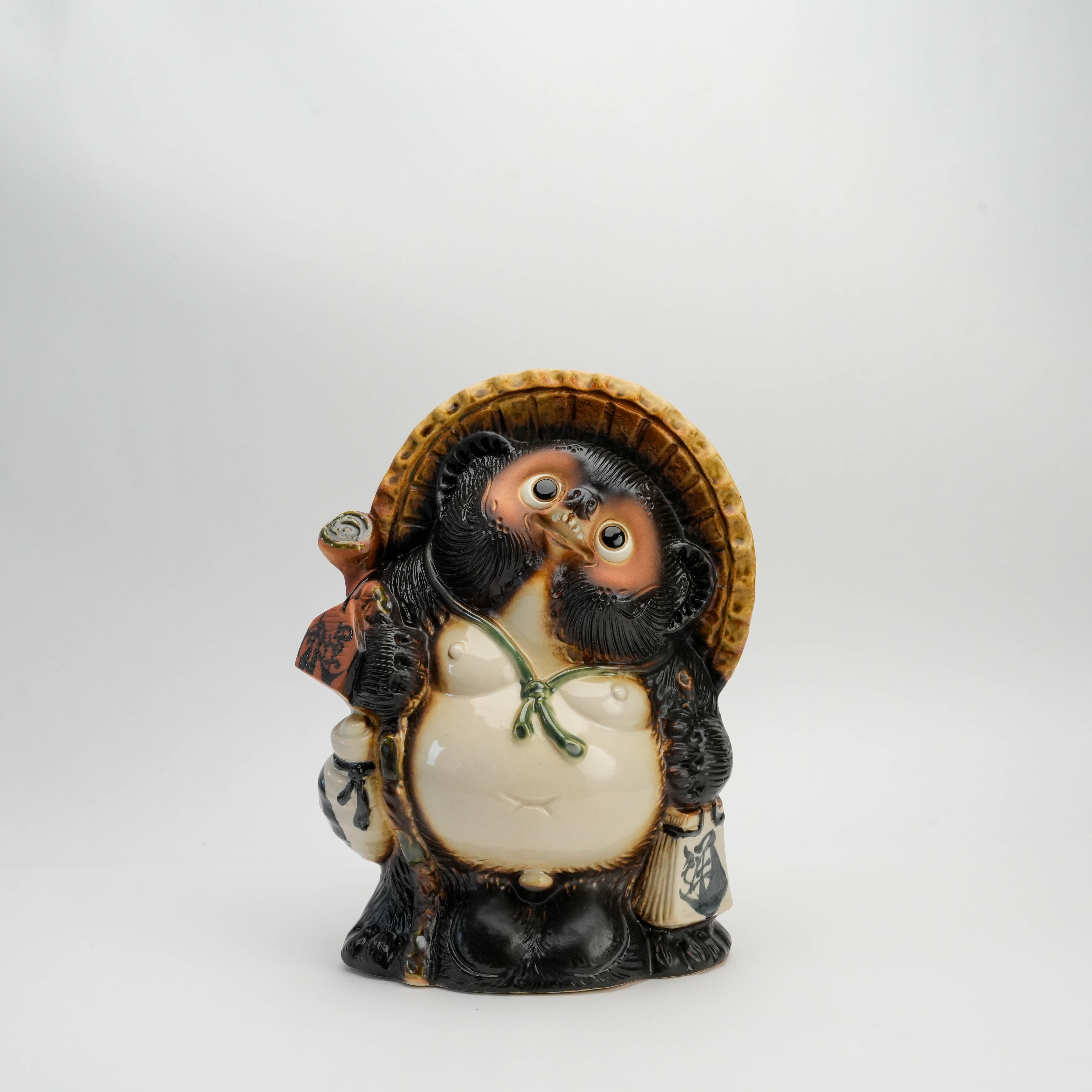 Shigaraki Kaiun Raccoon Dog Ornament - Lucky Tanuki figurine with straw hat and sake bottle, symbolizing prosperity in Japanese home decor.