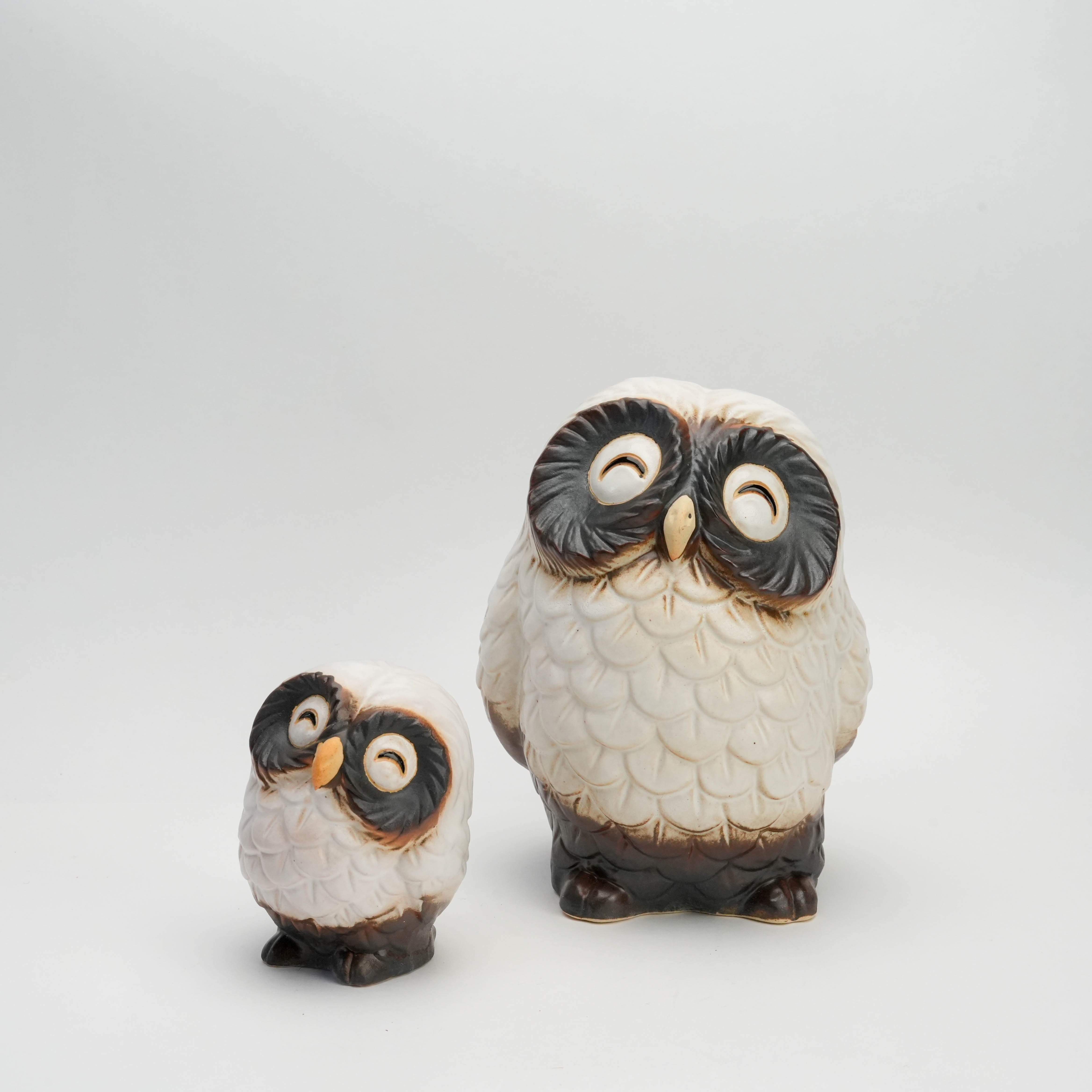 Set of two handcrafted Shigaraki Ware white smiling owl ornaments in ceramic, ideal for holiday decor or gifting. Features detailed feather texture.