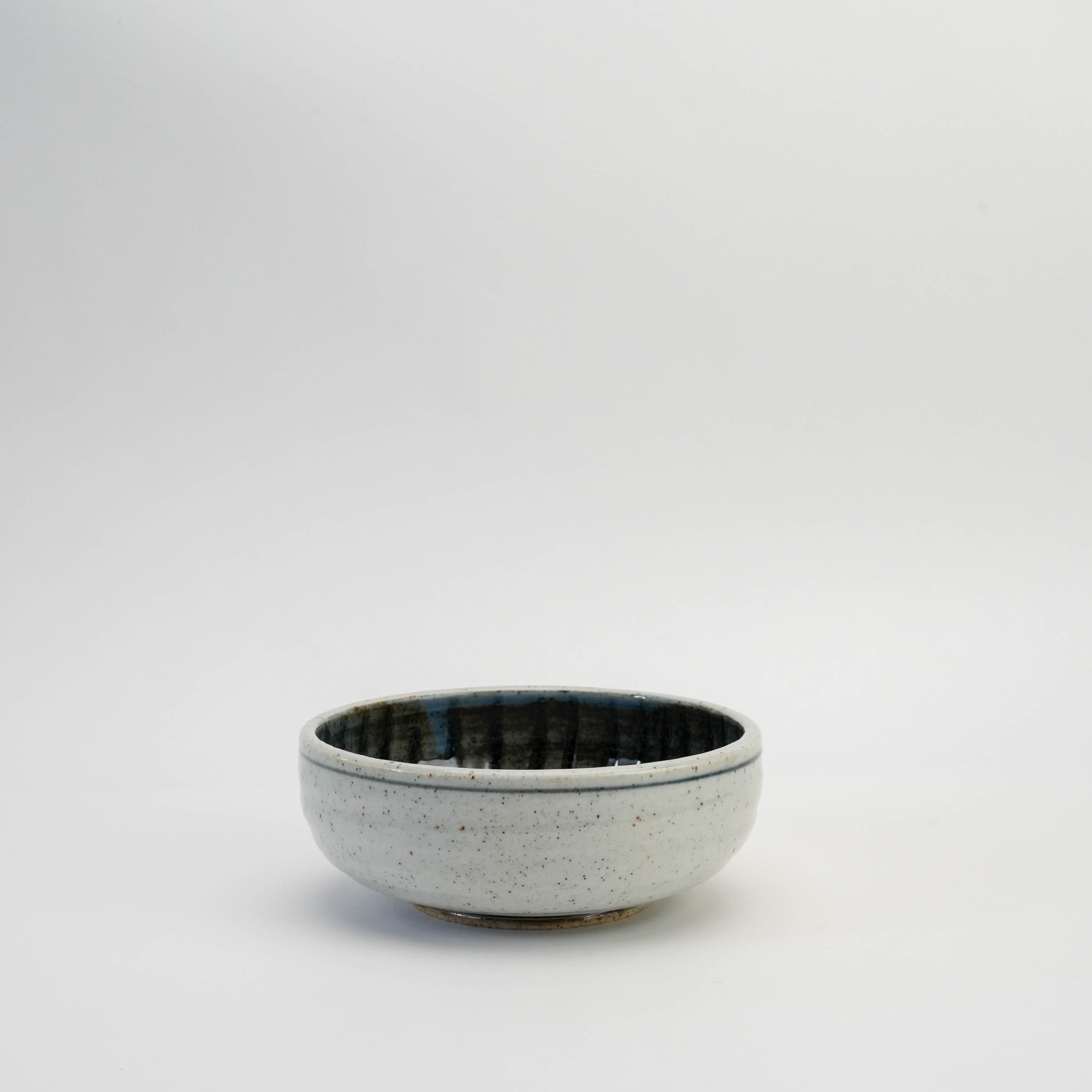 Mino Ware Ishiyaki Bowl with spiral indigo design, handcrafted in Gifu. Ideal for serving in Japanese-style dining settings.