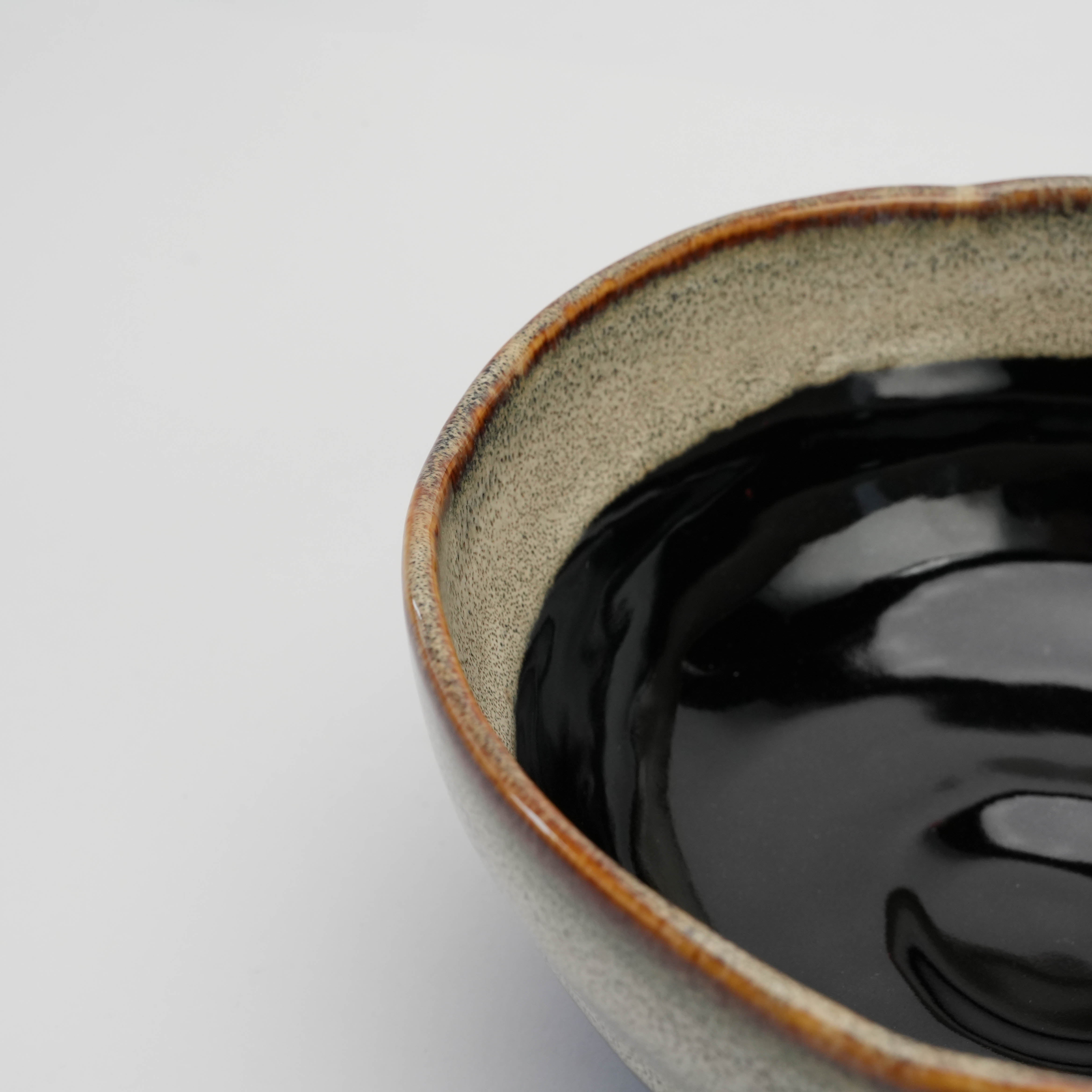 Close-up of Mino Ware Donburi Bowl rim and interior, showcasing the glossy black glaze and textured beige outer layer.