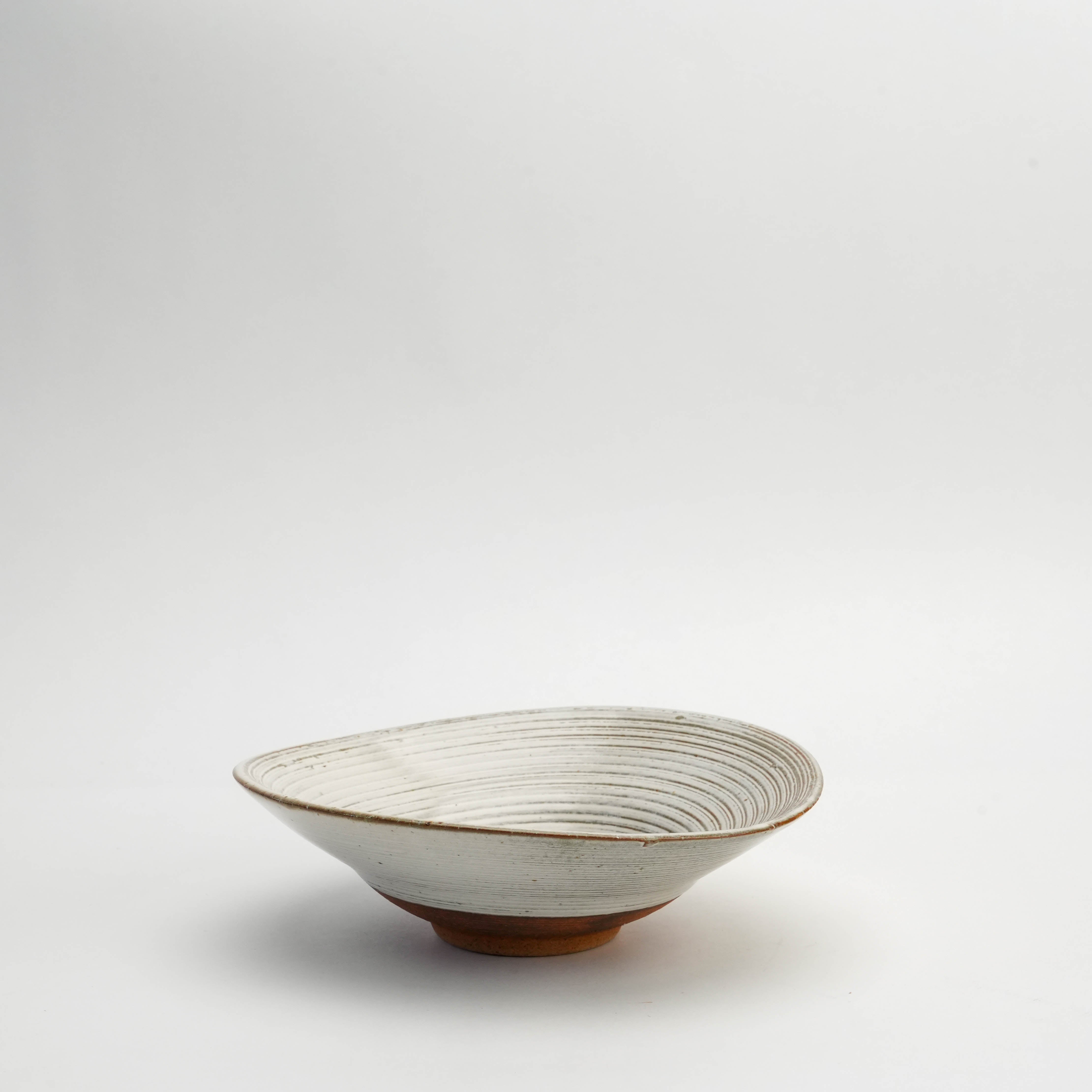 Mino Ware Kushime Bowl with white glaze and twisted shape, ideal for artisanal Japanese dining and elegant table settings.