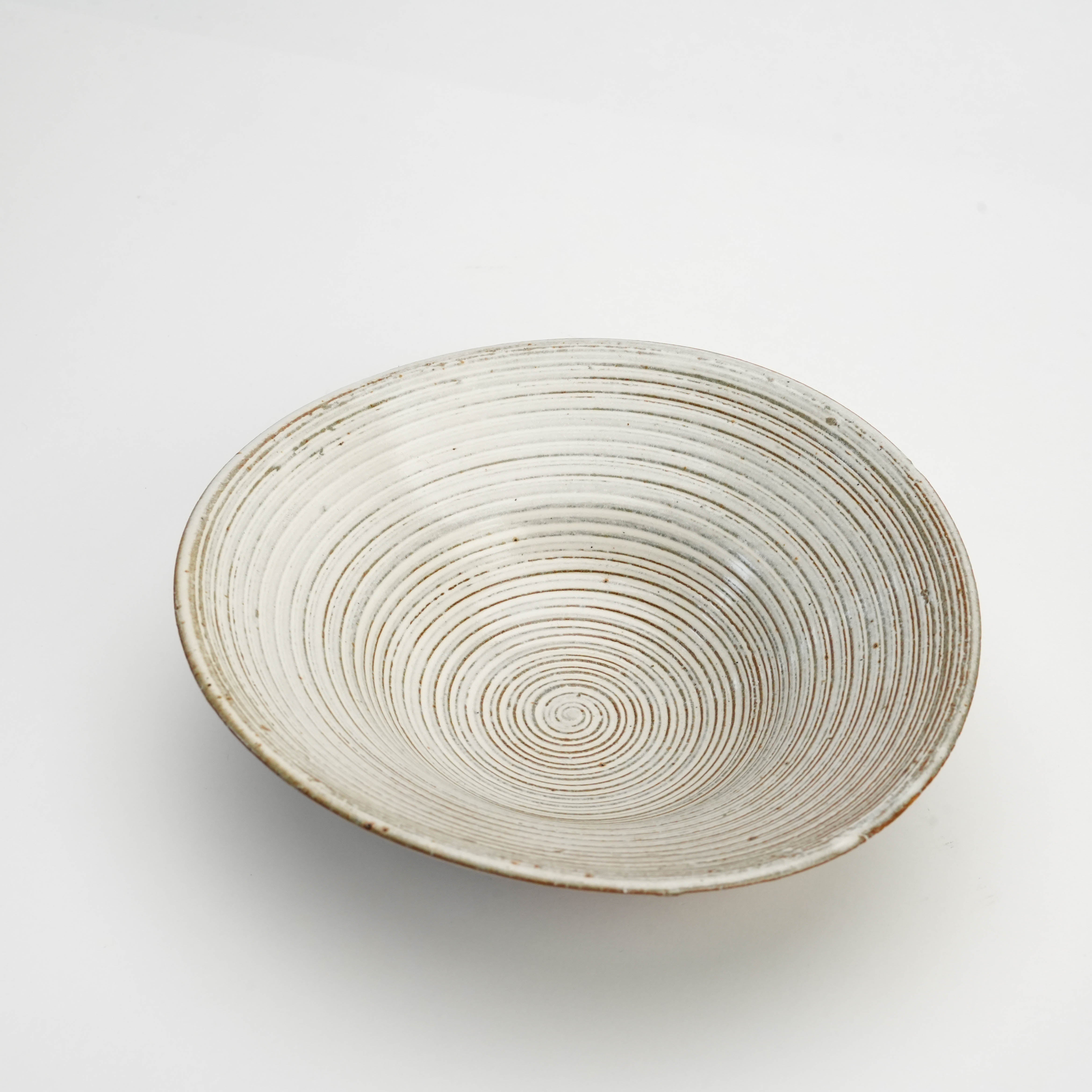 Top view of Mino Ware White Glaze Kushime Bowl showcasing its spiral texture and handcrafted twisted design for modern rustic dining.
