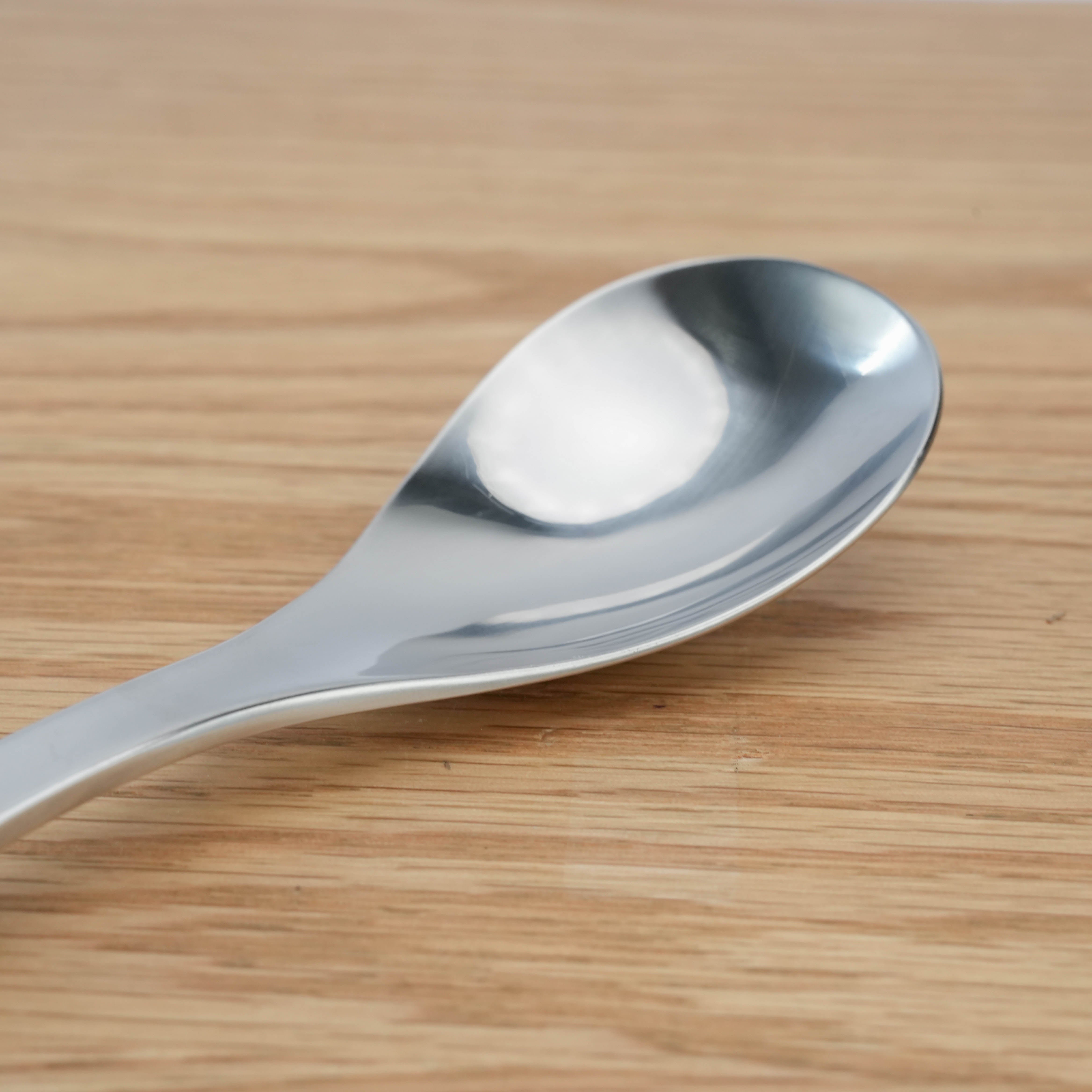 Close-up of Sori Yanagi Stainless Steel Dinner Spoon showcasing its smooth, polished bowl for elegant and functional dining.