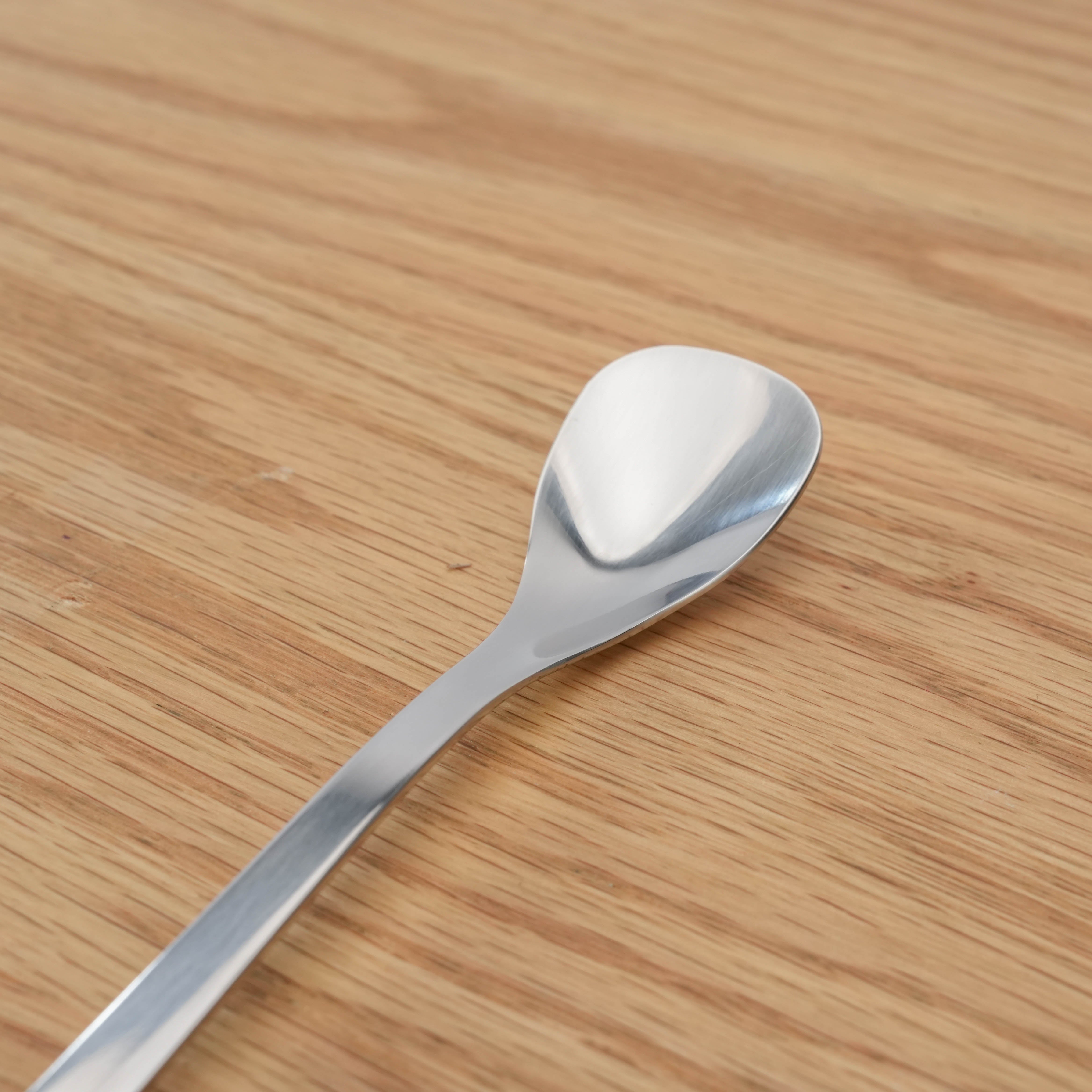 Close-up of Sori Yanagi Stainless Steel Parfait Spoon head, highlighting its smooth, polished finish and ergonomic shape.