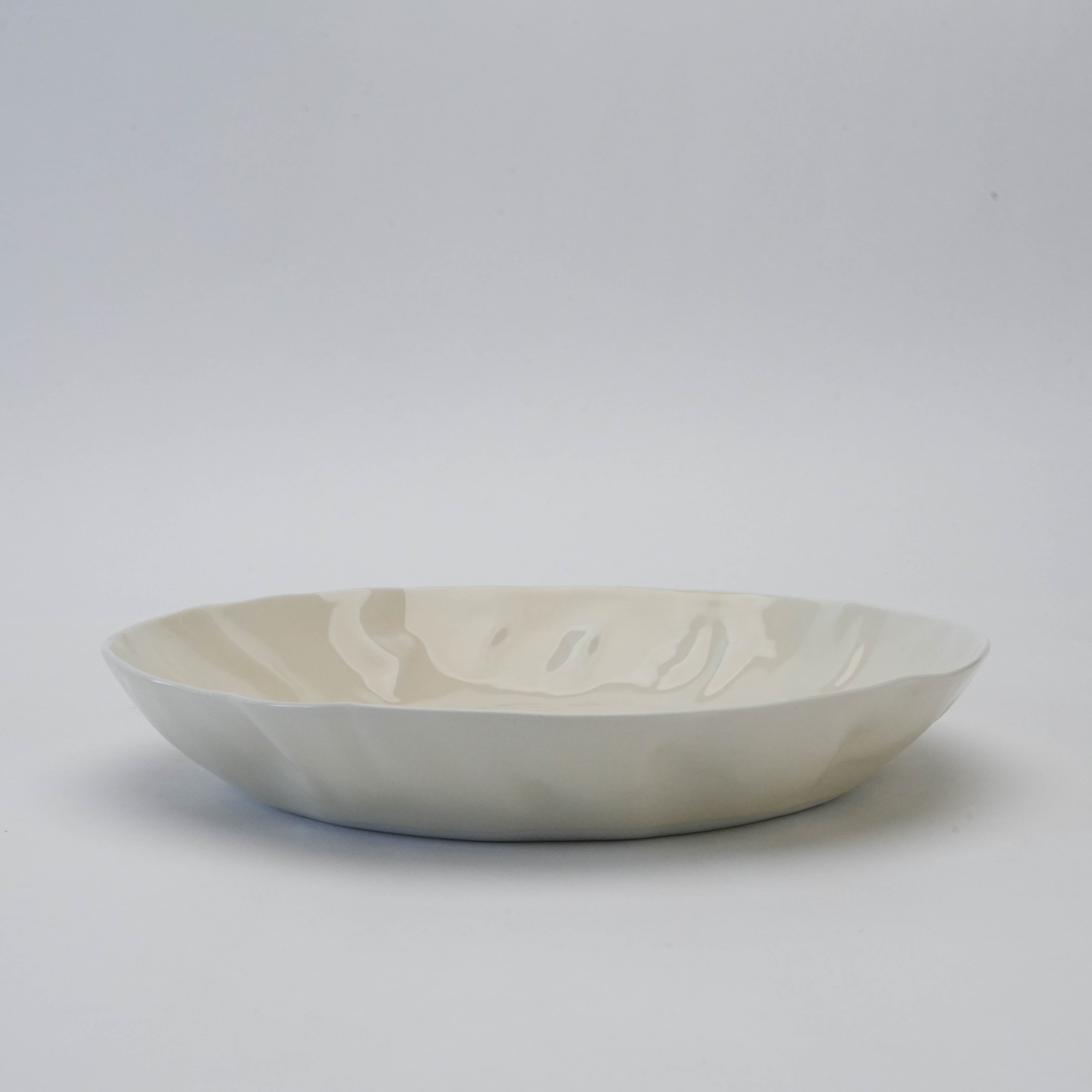 Side profile of white Hasami Ware Papyrus Pasta Dish featuring a soft crumpled design and smooth ceramic glaze for modern dining.