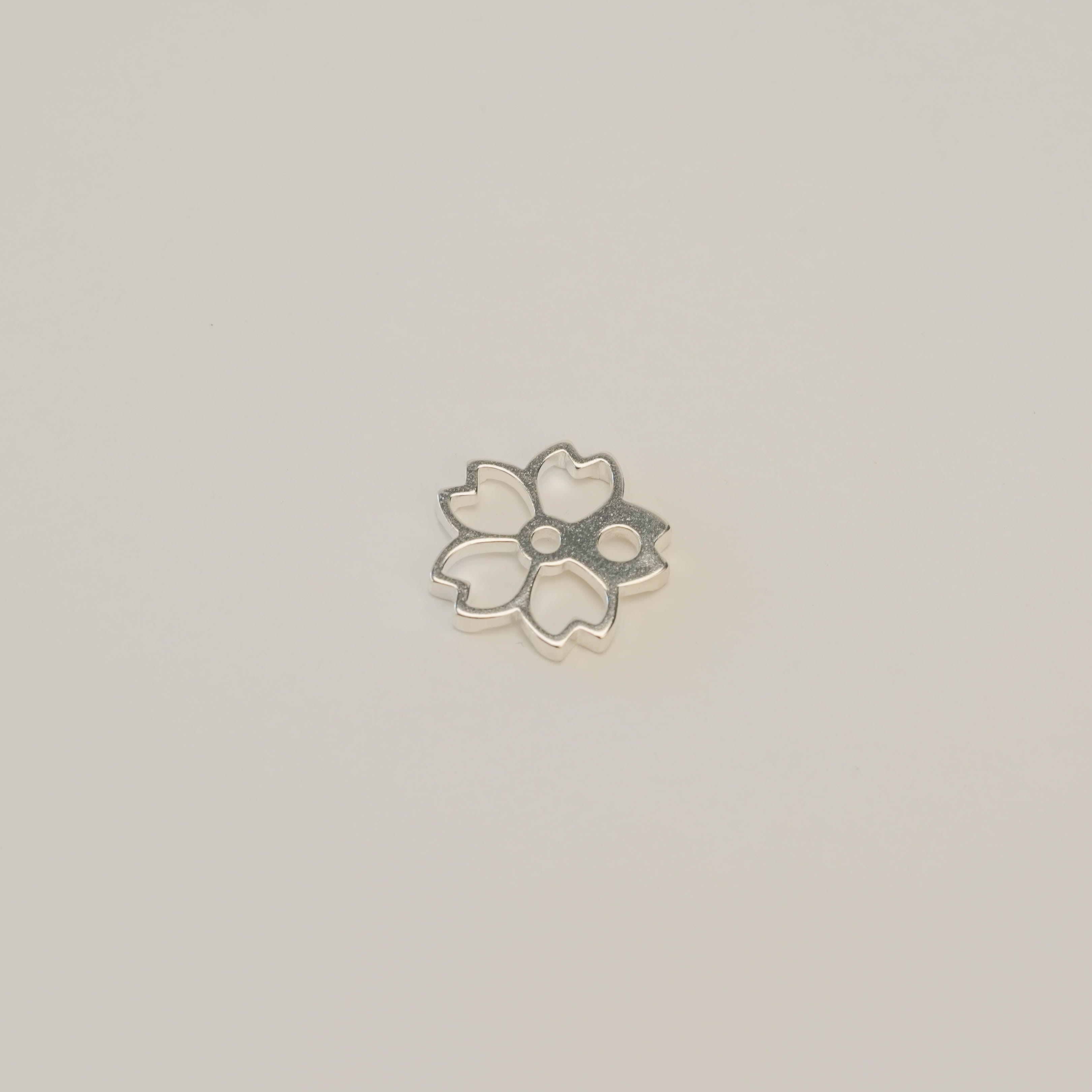 Shoyeido Silver Incense Holder - Cherry Blossoms in sterling silver, shaped like a delicate sakura flower. Ideal for minimalist home fragrance decor.