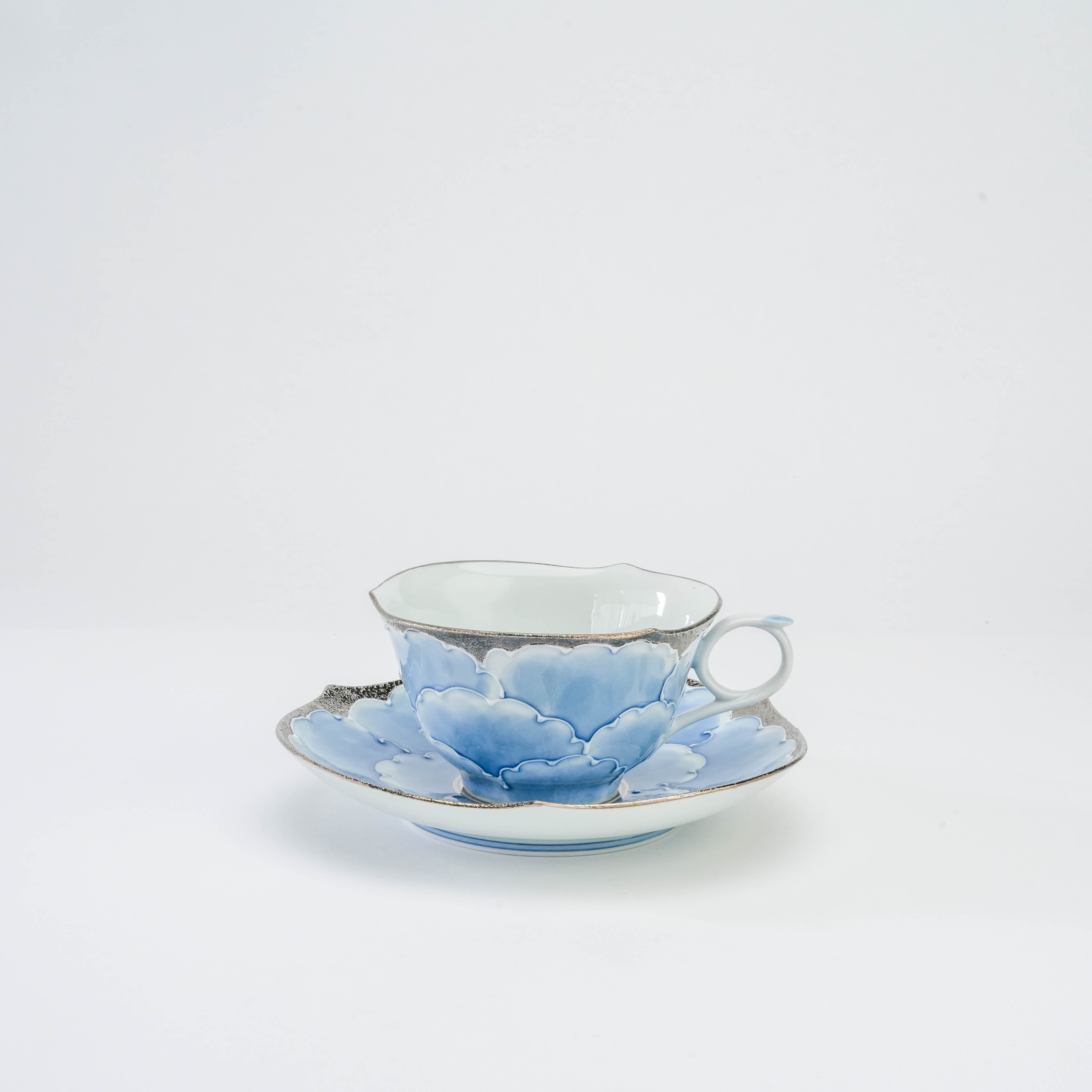 Bunzan Kiln Cup & Saucer - Arita Peony Porcelain in blue, silver, and white with scalloped edges and floral design, ideal for elegant tea settings.