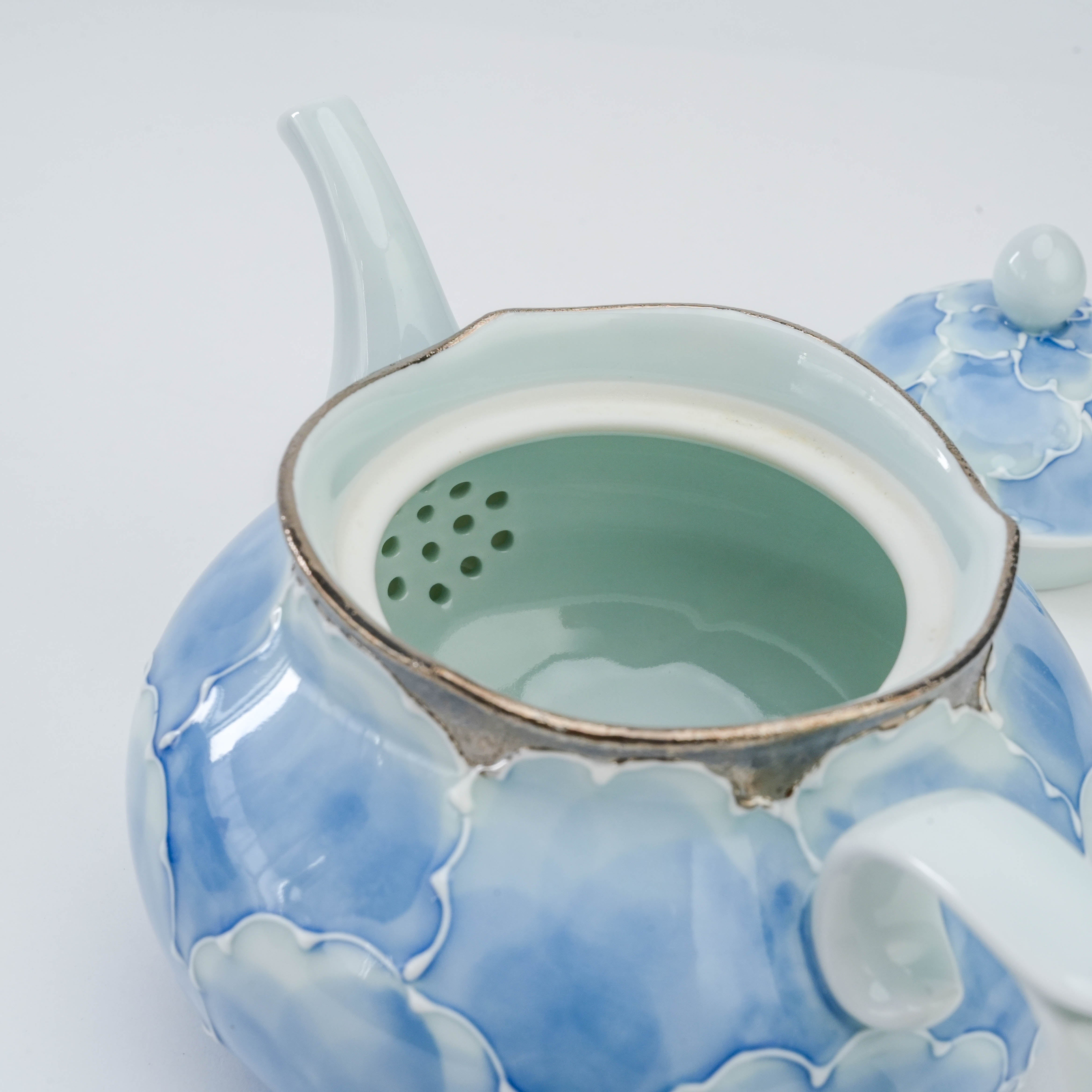 Interior view of the Bunzan Arita Peony Teapot revealing the built-in ceramic strainer and smooth glazed finish.