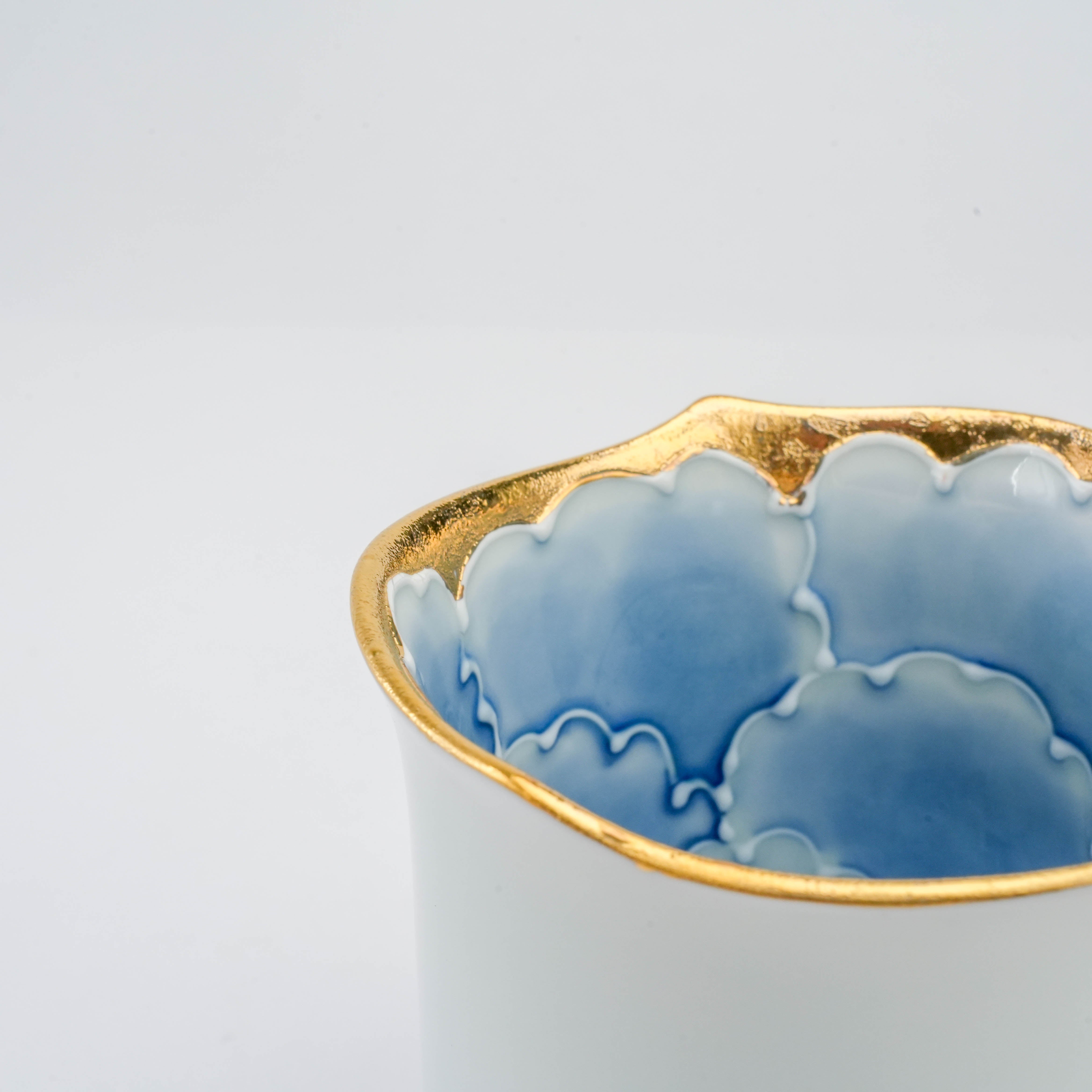 Close-up of Arita Ware Peony Mug rim highlighting intricate gold trim and blue floral inner pattern, ideal for premium porcelain tableware.