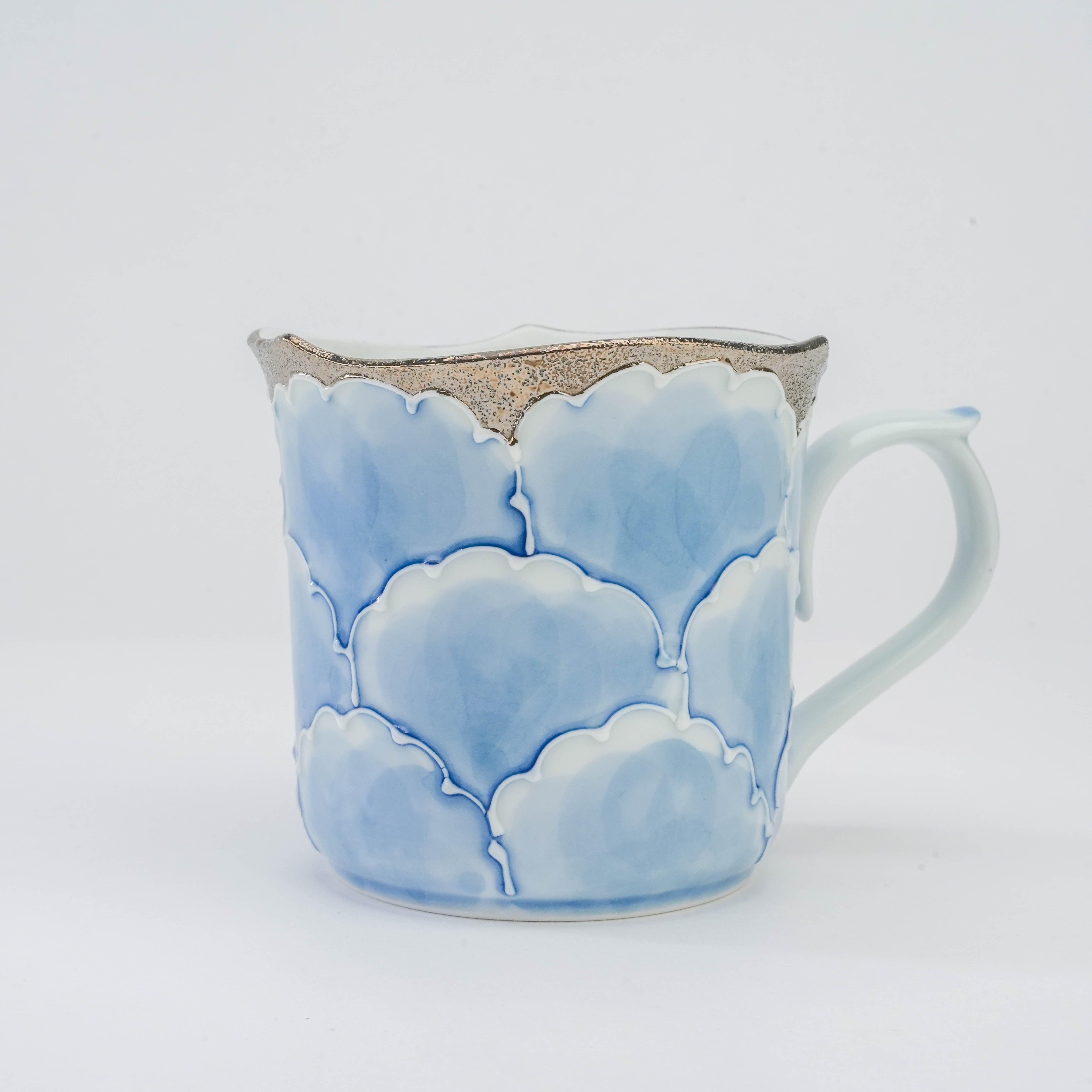 Close-up of Arita Ware Peony Mug in blue and silver with embossed floral design and shimmering silver edge, ideal for elegant drinkware collections.