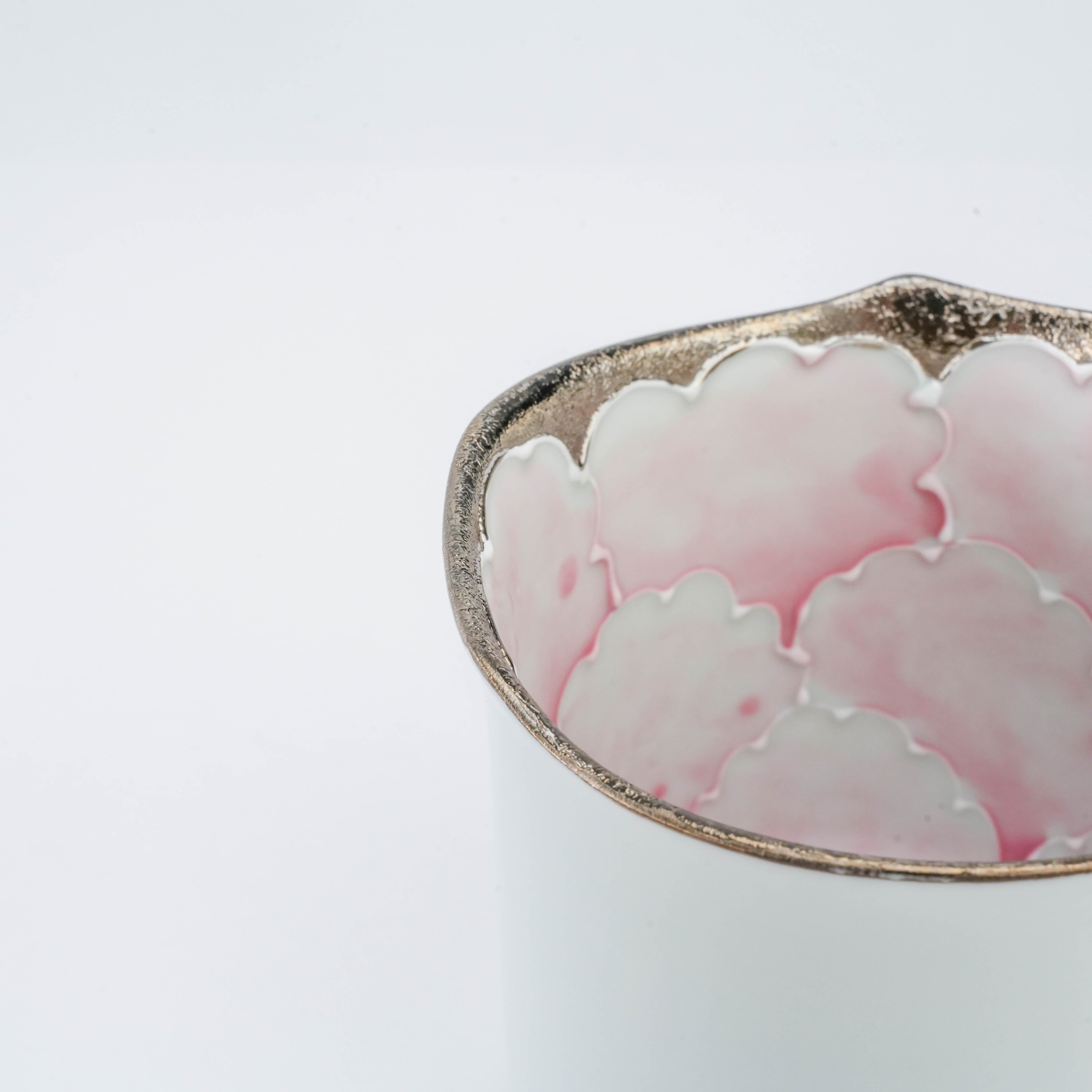 Close-up of Peony Mug by Bunzan Kiln highlighting silver rim and delicate pink peony petal design on the inner porcelain surface.