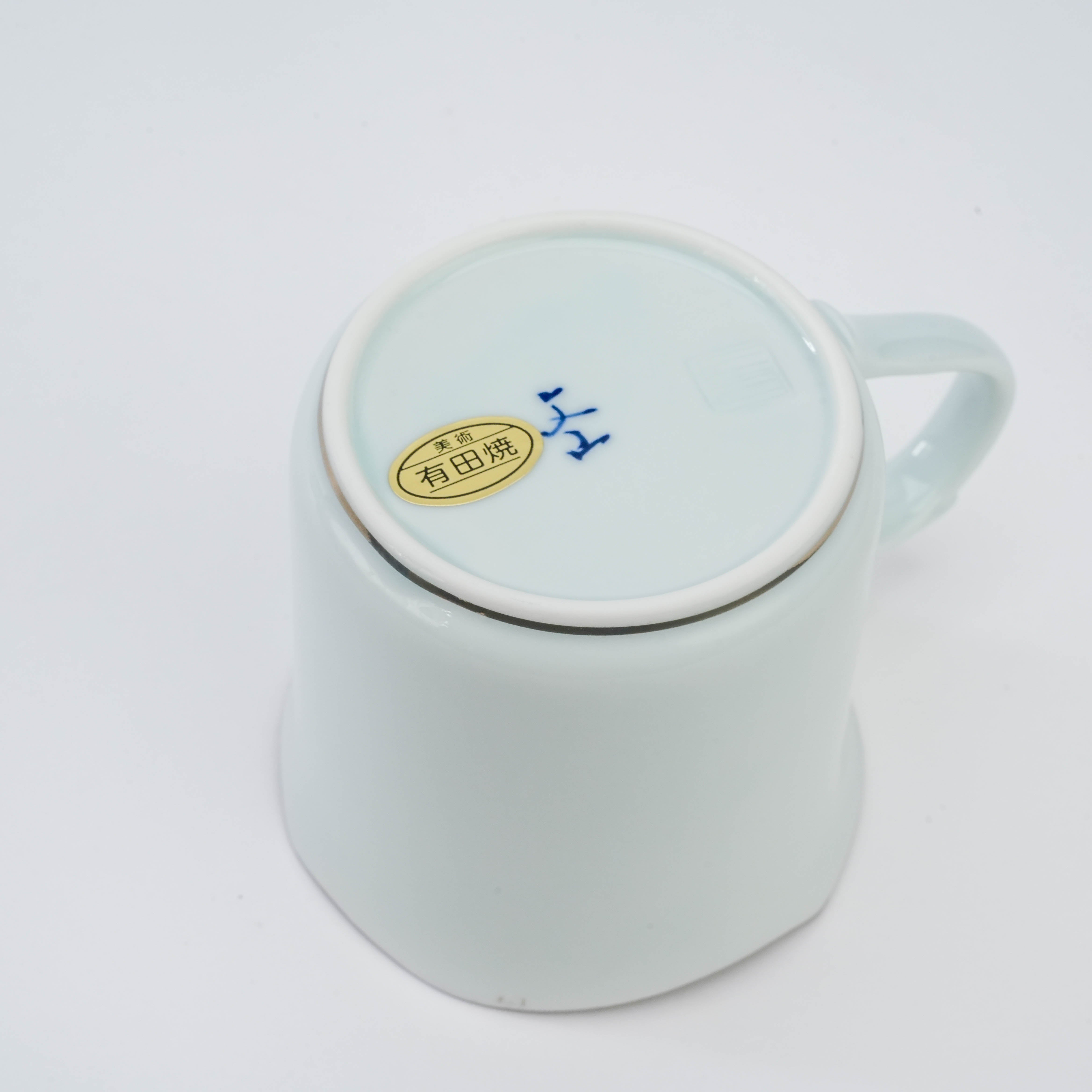 Bottom of Arita Peony Mug by Bunzan Kiln featuring kiln mark and authenticity sticker, fine porcelain craftsmanship from Japan.