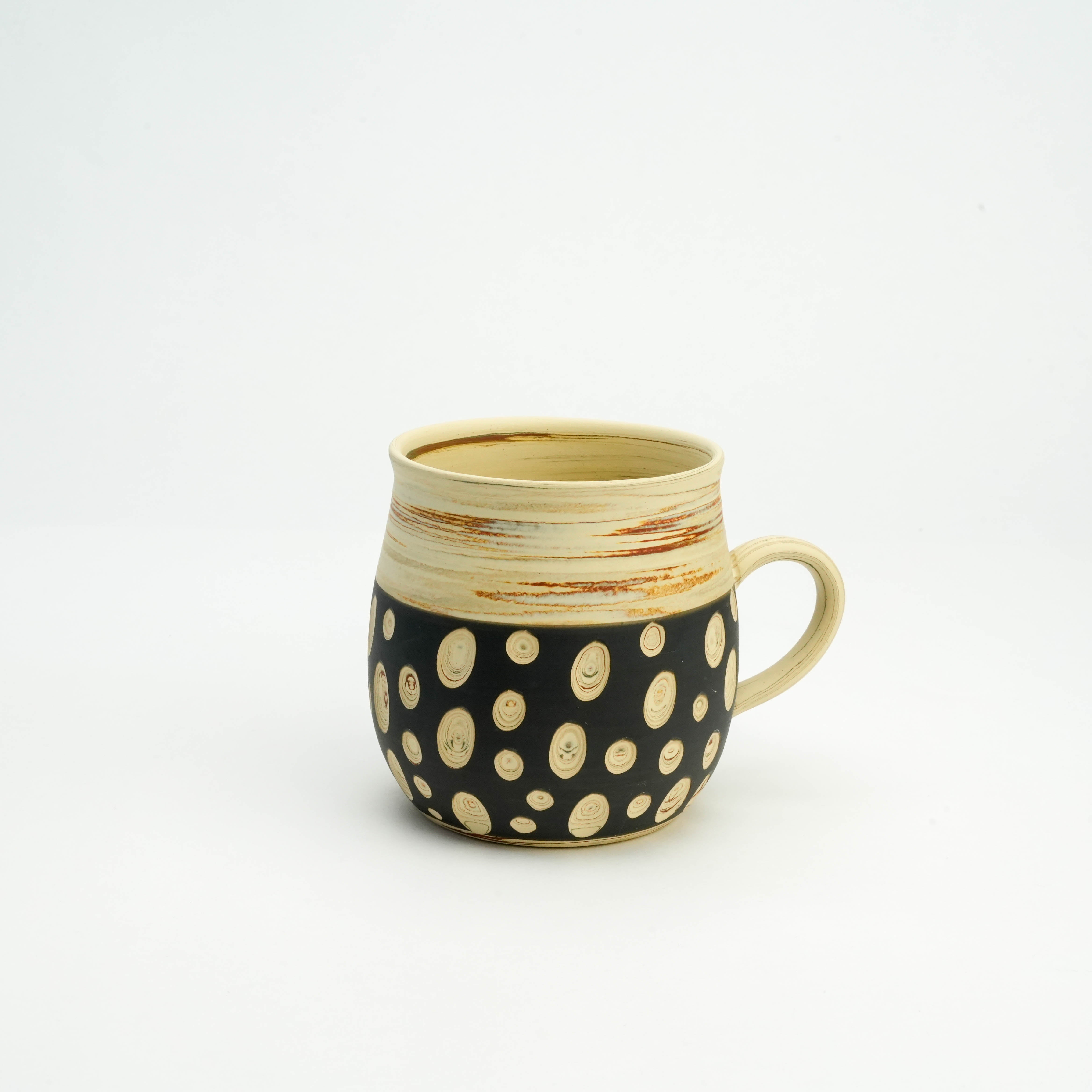 Polka Dot Tokoname Mug by Kenji Touen featuring black ceramic body with hand-carved cream dots, perfect for modern rustic kitchen decor.