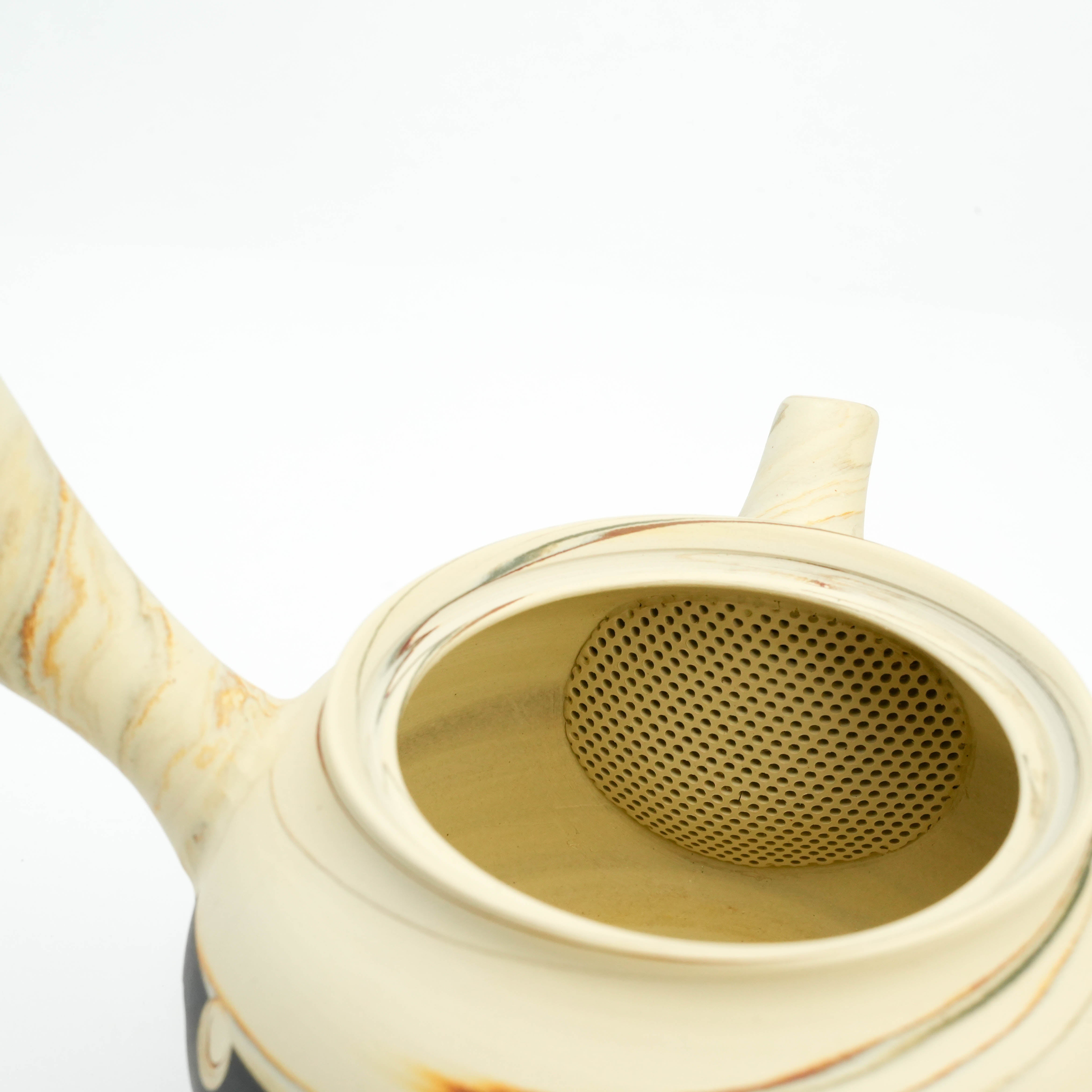 Interior view of Tokoname Teapot showing built-in ceramic strainer and smooth nerikomi clay finish, ideal for loose leaf tea.