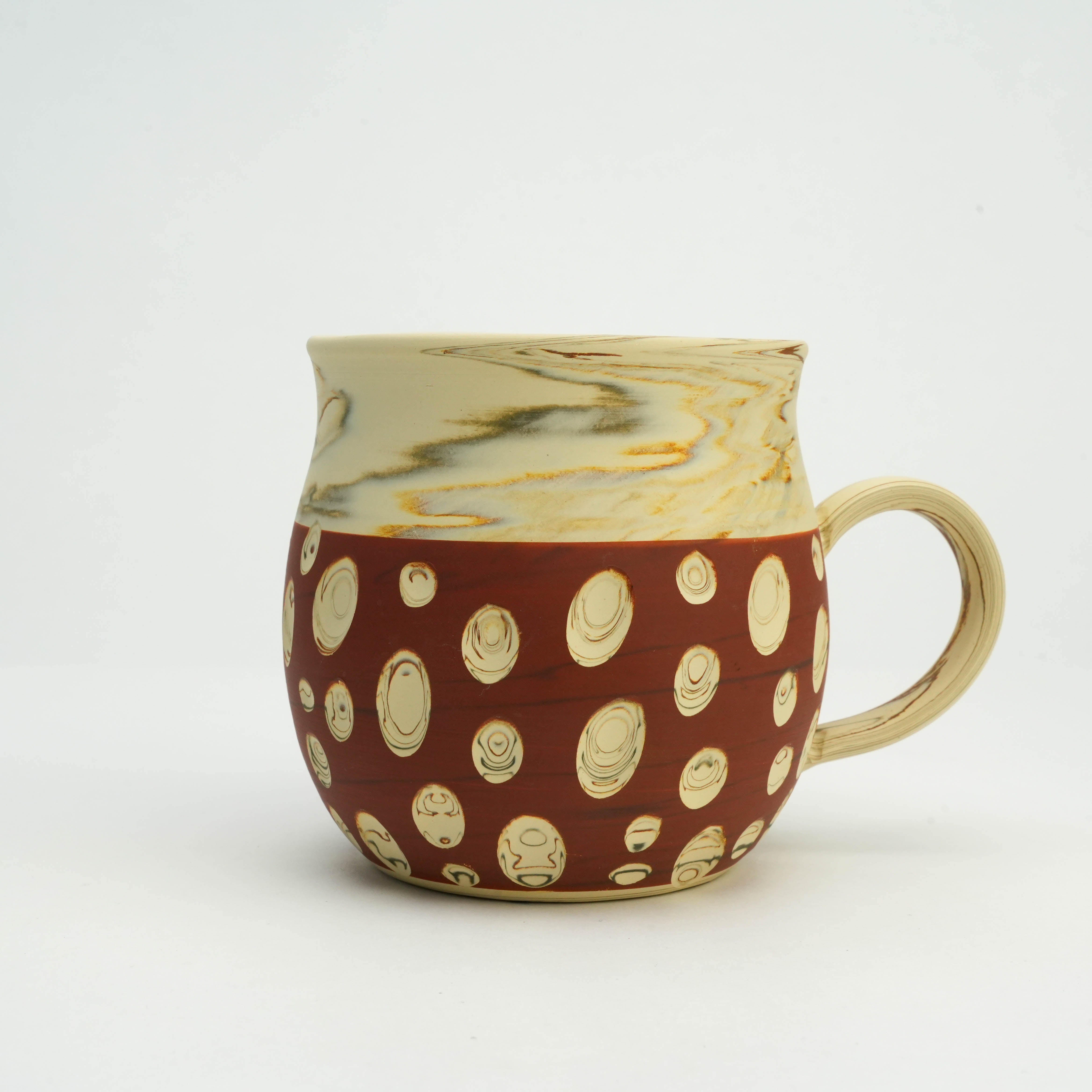 Side view of Tokoname Ware Polka Dot Mug in red, highlighting its round body, textured handle, and intricate dot pattern.