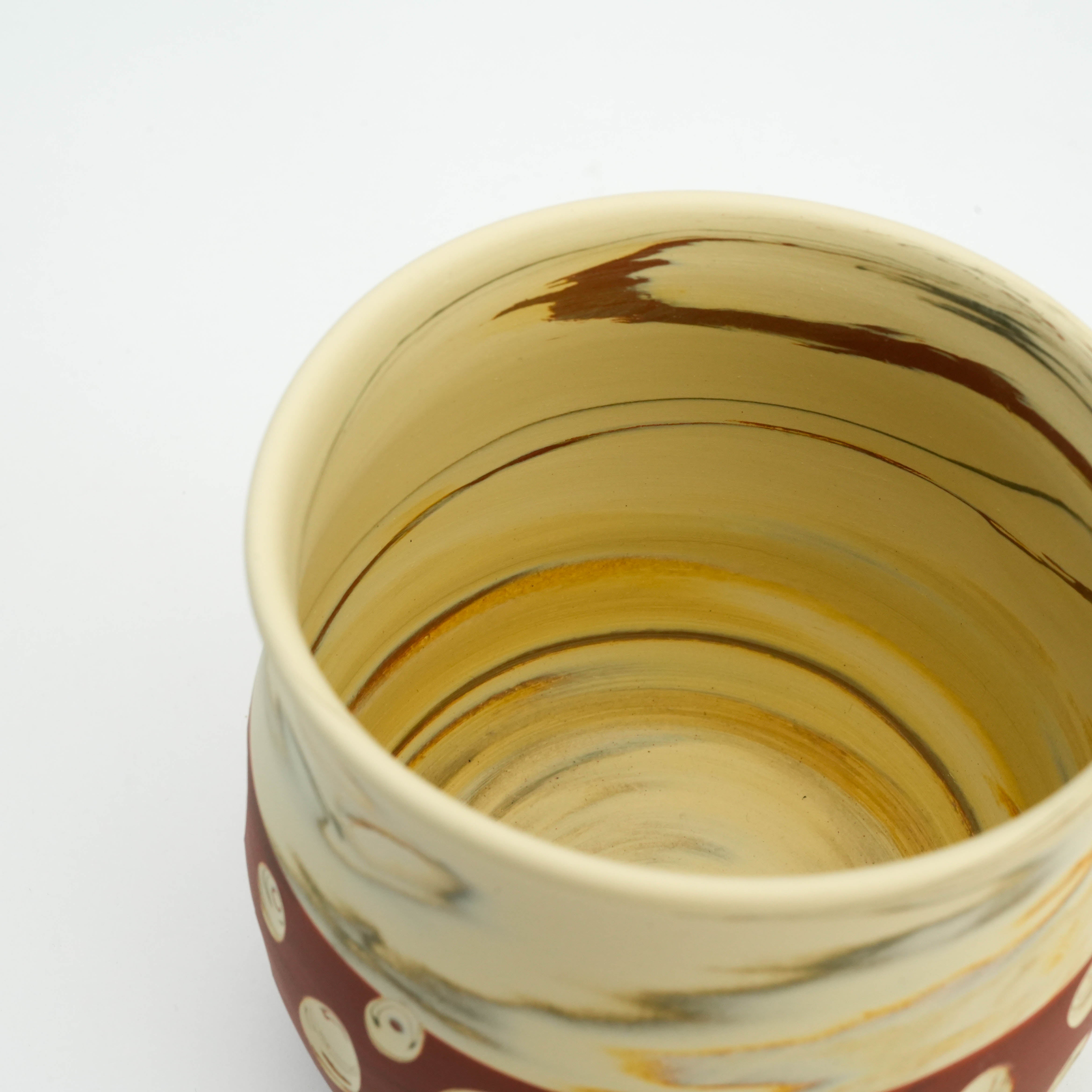 Interior view of Tokoname Ware Mug Red - Polka Dot Design, revealing swirling marbled glaze and smooth ceramic finish.