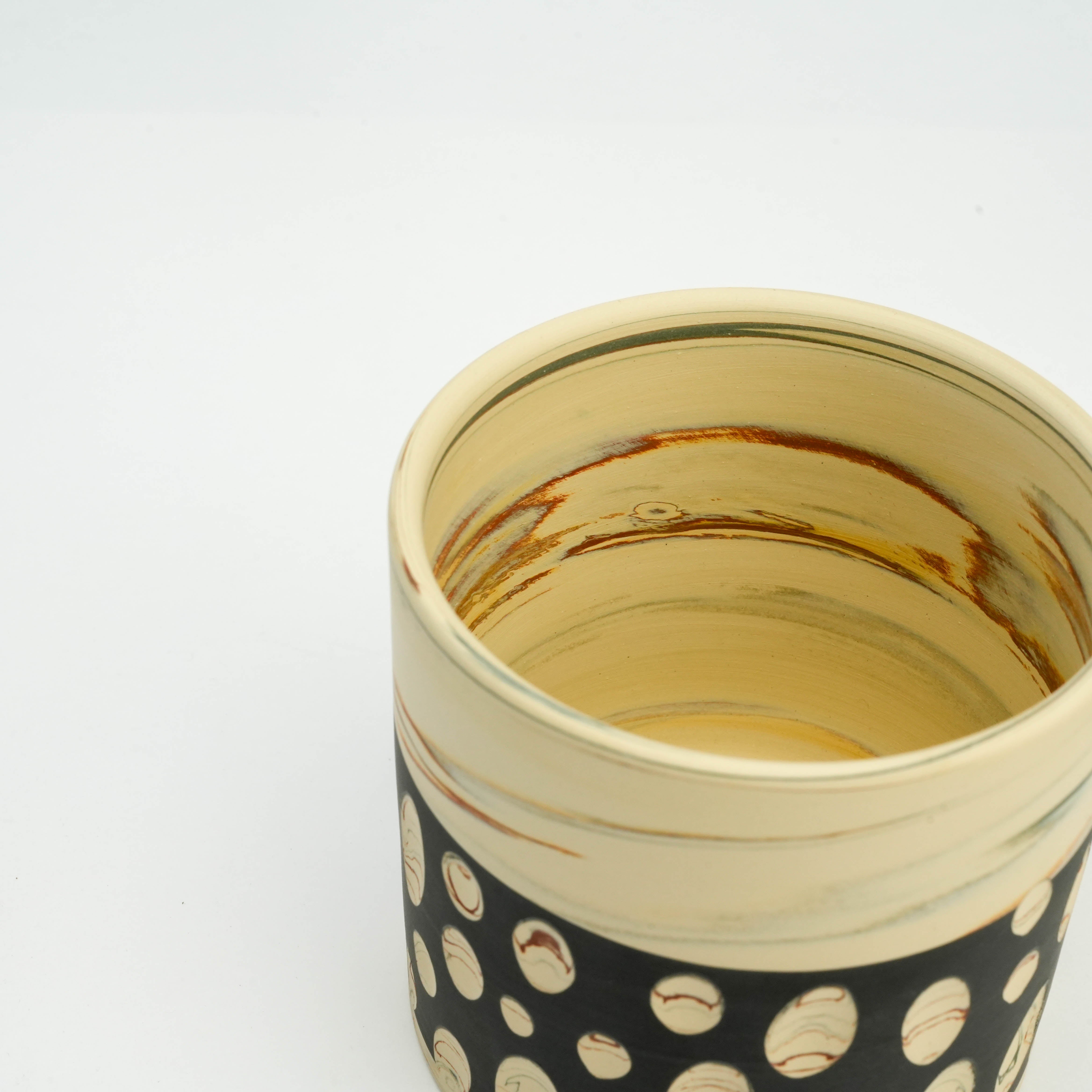 Interior view of Tokoname Ware Polka Dot Mug - Black, showcasing natural clay swirls and artisanal finish for a unique handcrafted drinkware piece.