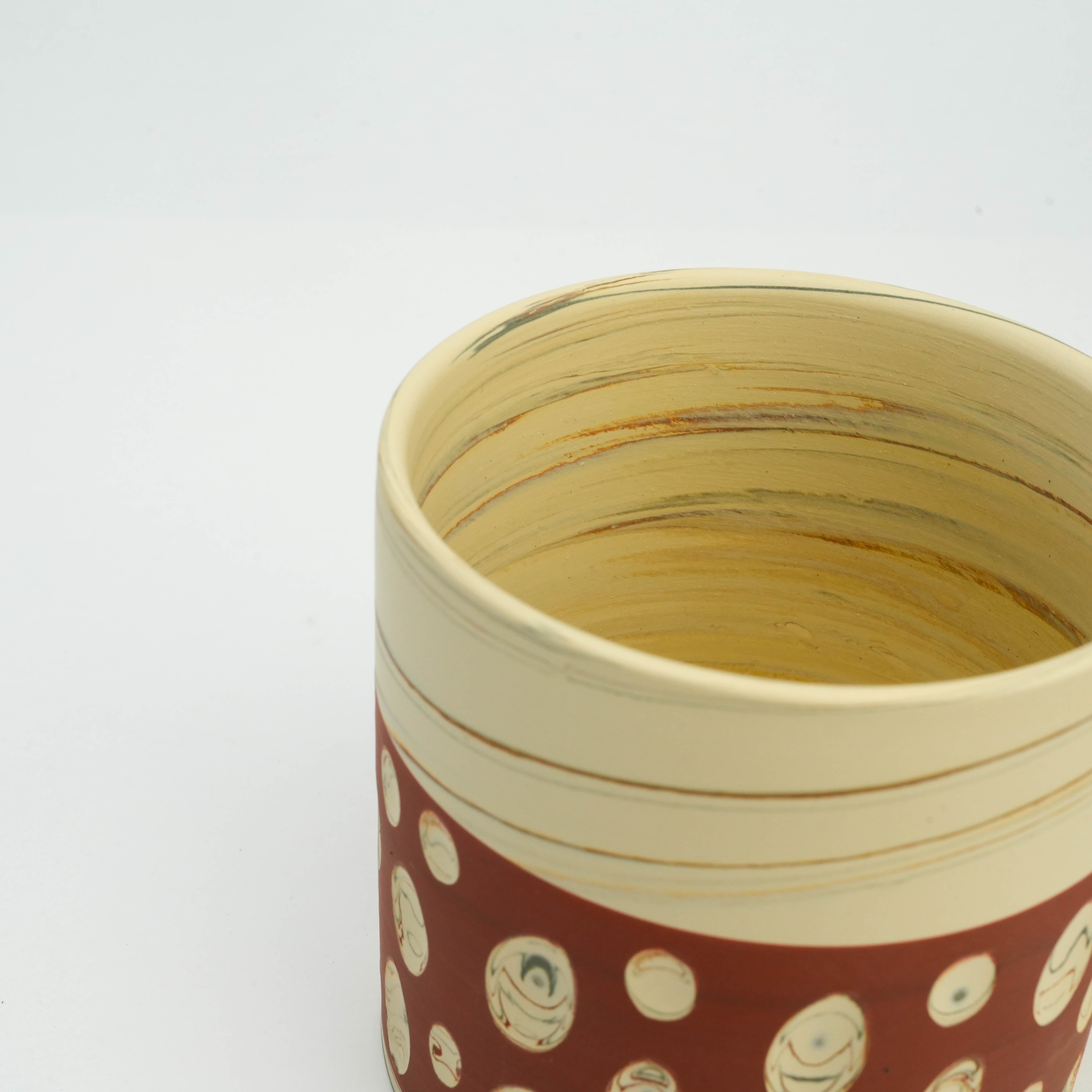 Interior view of handcrafted Tokoname polka dot mug showing earthy-toned nerikomi swirls, perfect for home and garden drinkware use.