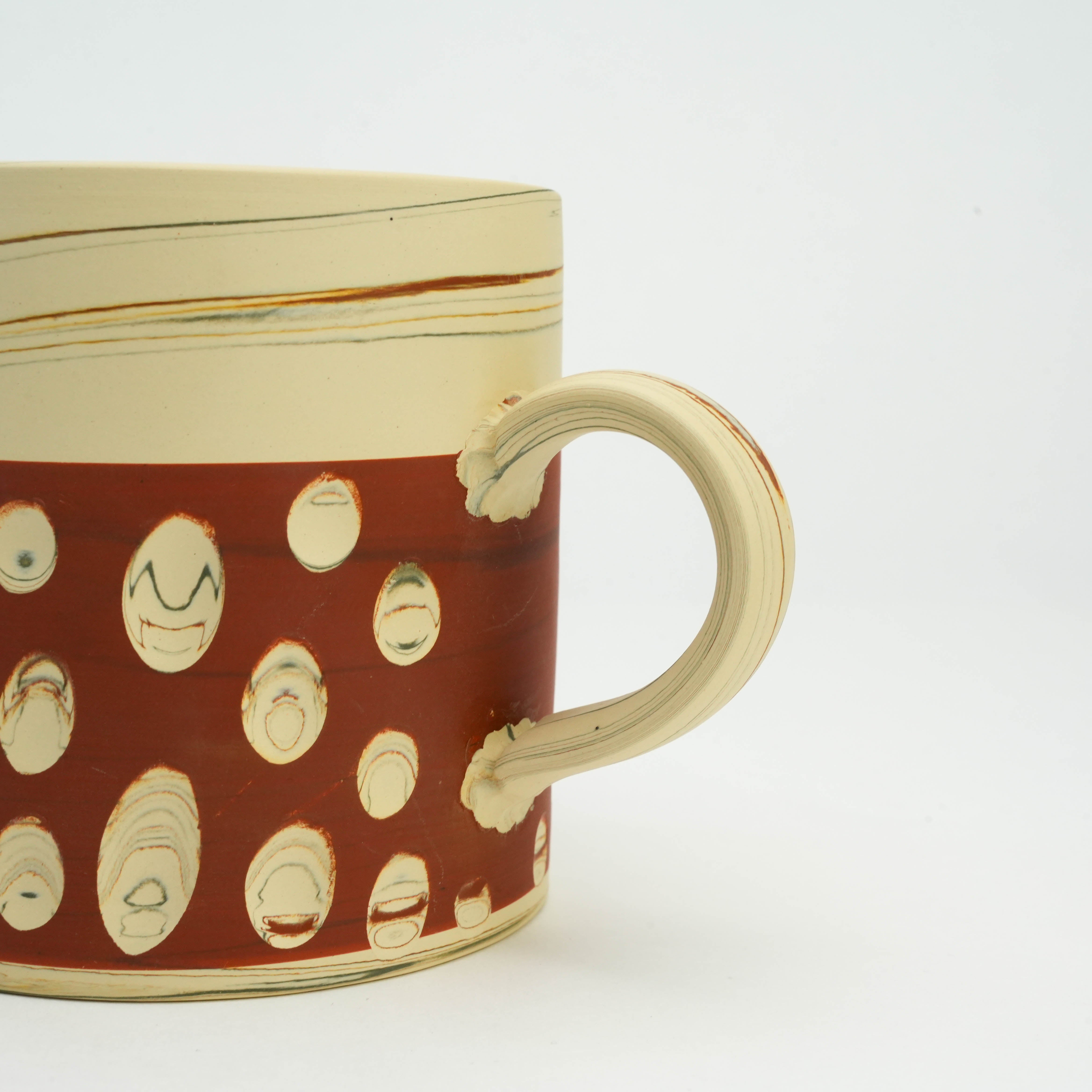 Detailed handle view of Tokoname Ware Polka Dot Mug in red, highlighting artisanal texture and Japanese pottery technique.