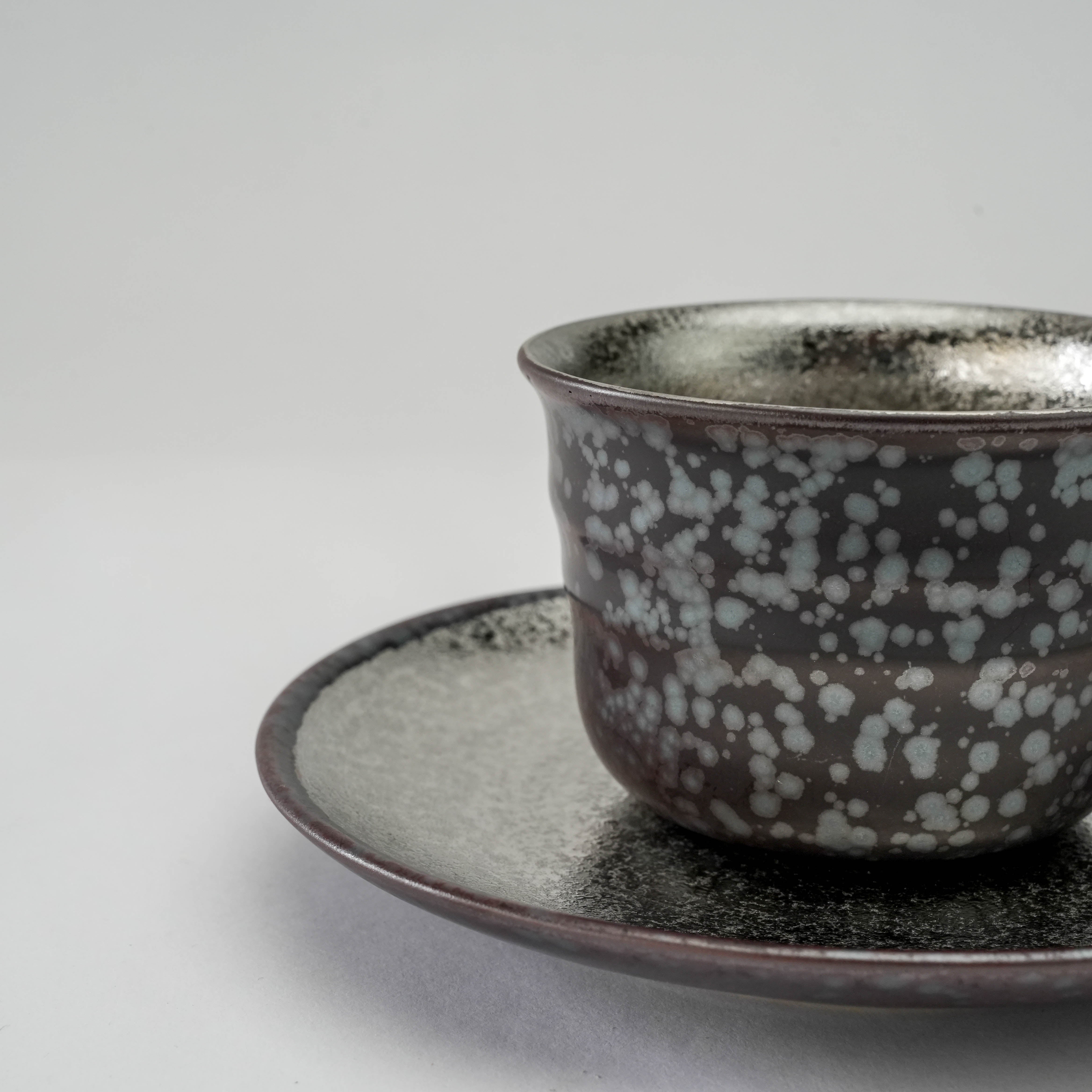 Side angle of Arita Ware Silver Coffee Cup on saucer, emphasizing textured crystal glaze and artisanal quality. A new arrival in premium coffee sets.