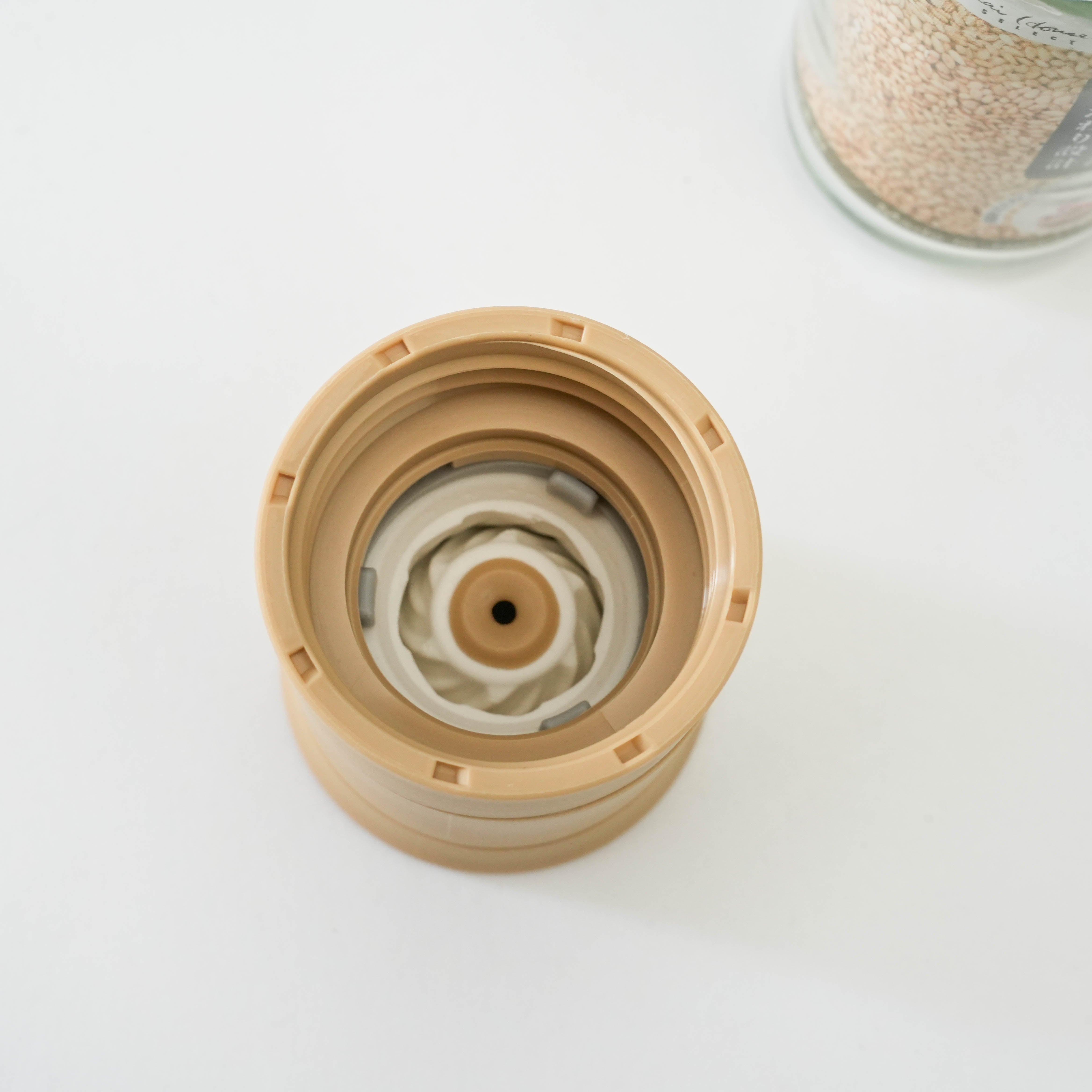 Close-up of Kai Home Sesame Grinder’s ceramic blade mechanism, designed for efficient sesame seed grinding and flavor release.