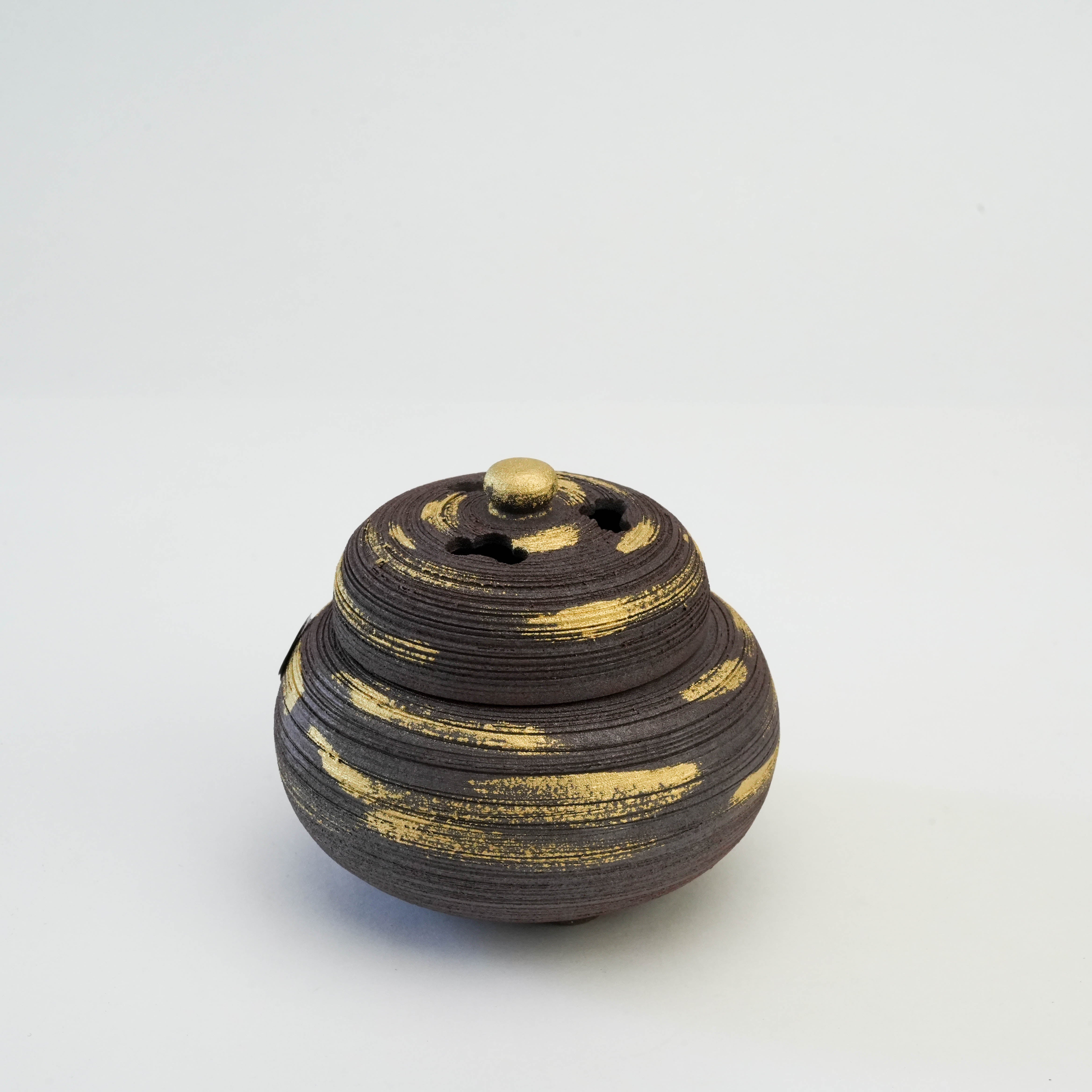 Front view of Shoyeido Incense Censer - Nanban Style featuring textured ceramic body with gold brush accents.