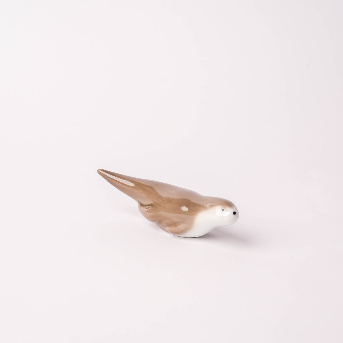 Hand-painted Arita Ware otter-shaped chopstick rest with detailed facial features and a glossy finish, perfect for Japanese dining.