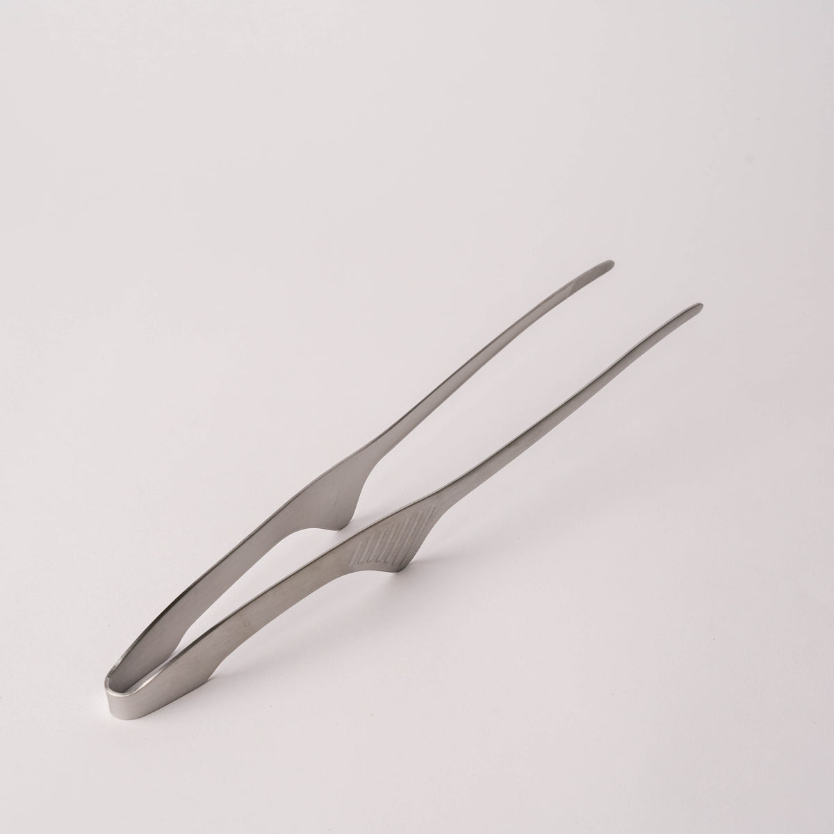 Stainless steel kitchen tongs with textured grip and slim design, ideal for cooking and serving, SKU: 2052551