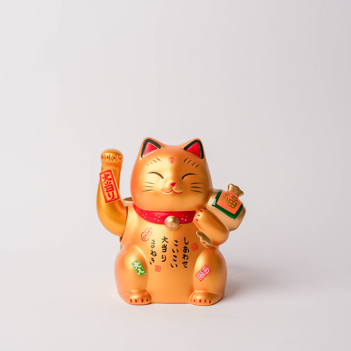Gold Lucky Cat figurine with a waving paw, detailed with Japanese characters and symbols, perfect for home decor