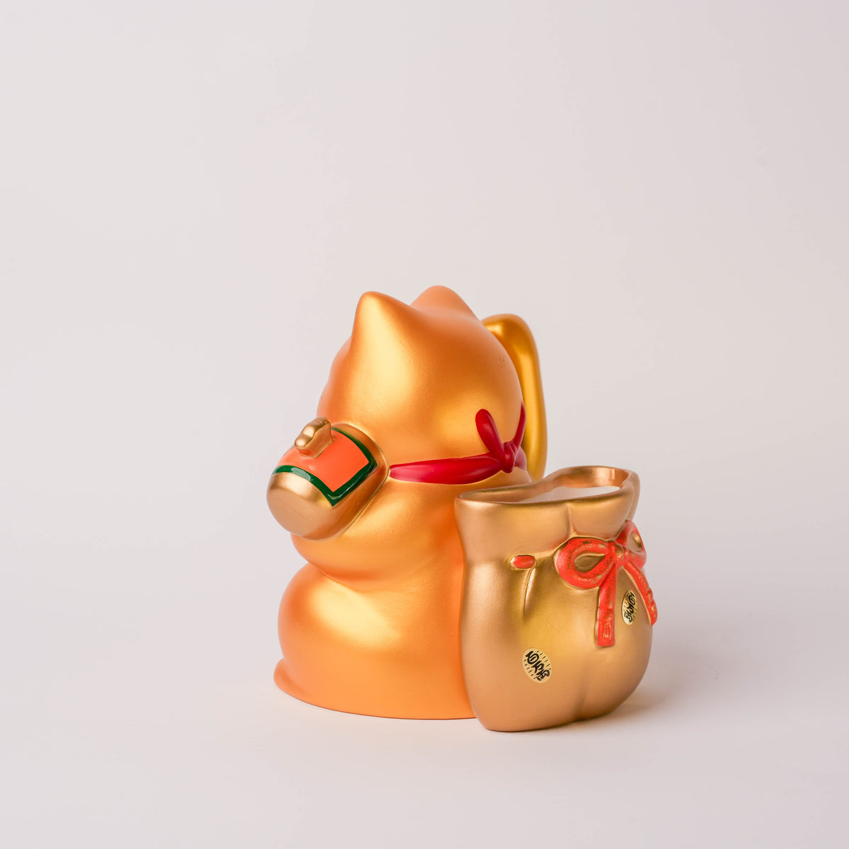 Side angle of the Lucky Cat with detailed Japanese inscriptions on its body, gold finish, and decorative accents