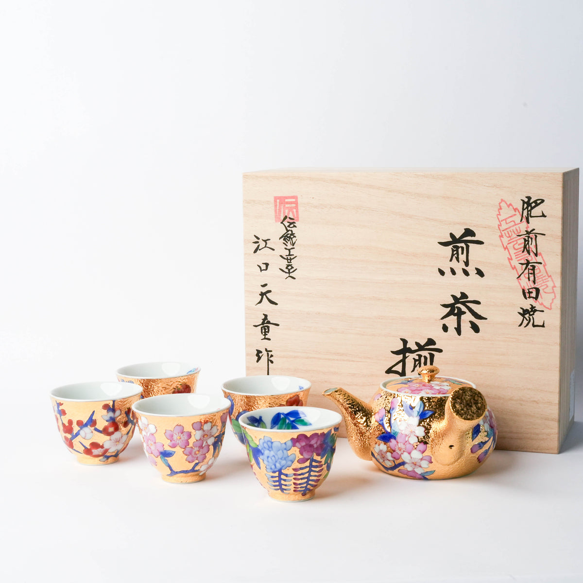 Colorful hand-painted floral tea set with gold accents, includes teapot and cups, perfect for elegant tea ceremonies.