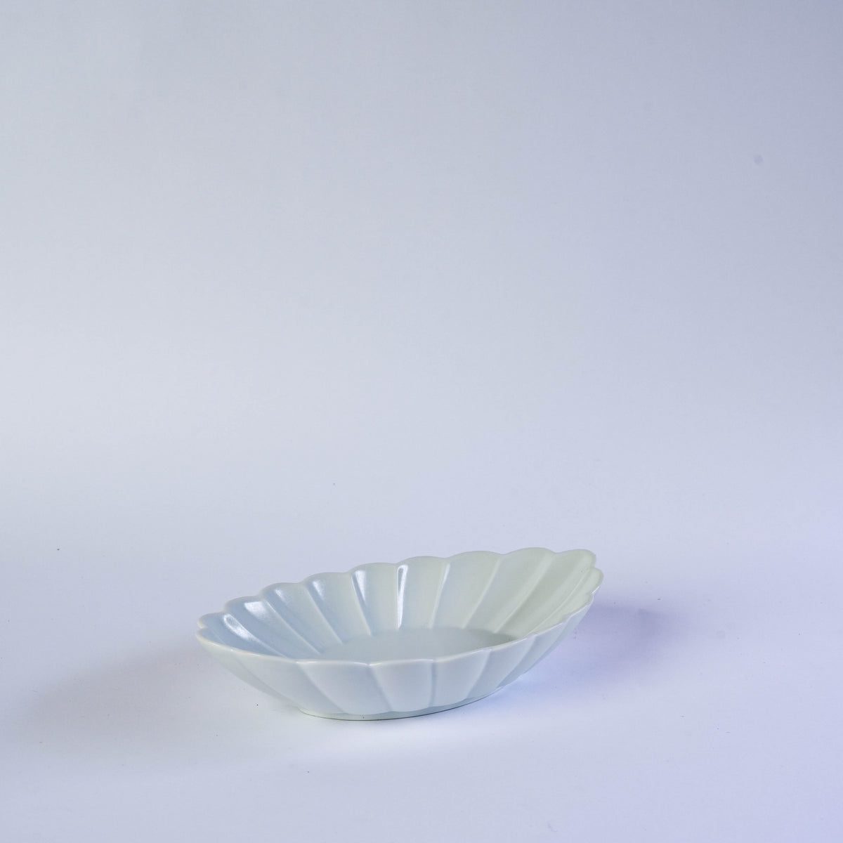 White carved oval plate with floral pattern, ceramic material, elegant for dining, SKU: NPSF1010