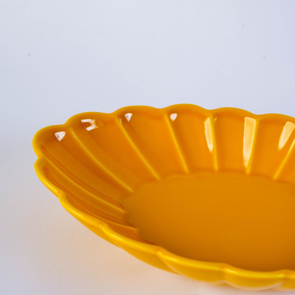 Yellow carved oval plate with floral design, made of ceramic, versatile for serving appetizers or desserts, SKU: NPSF1010
