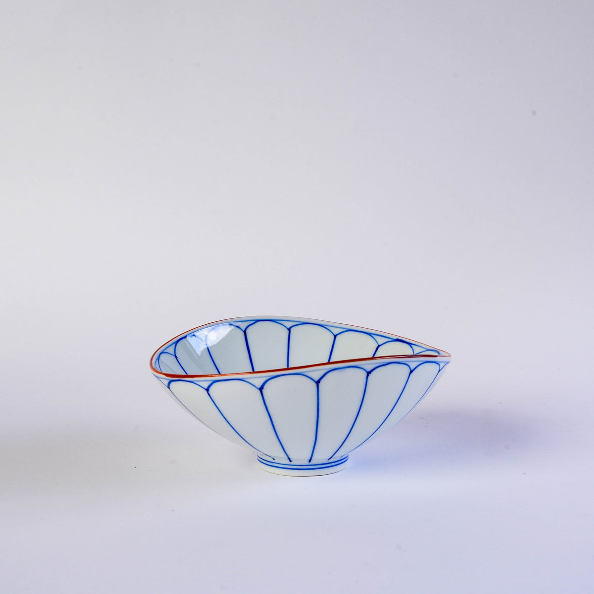 White porcelain oval bowl with blue floral pattern and orange rim, Japanese design, ideal for serving appetizers or desserts