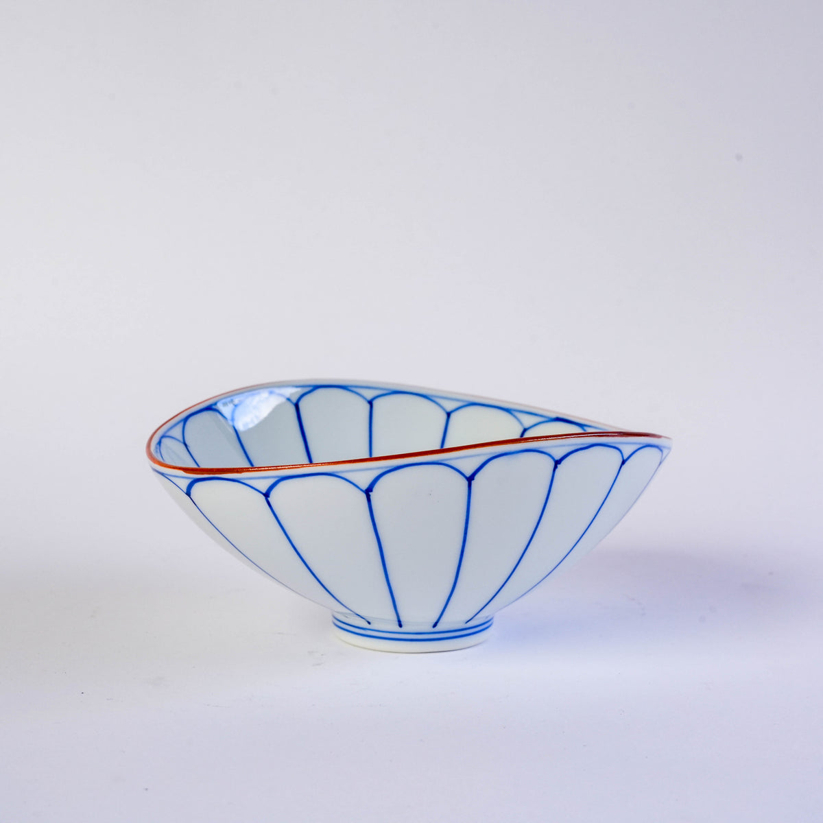 Bottom view of the porcelain bowl showing the blue pattern and the label indicating it is made in Japan