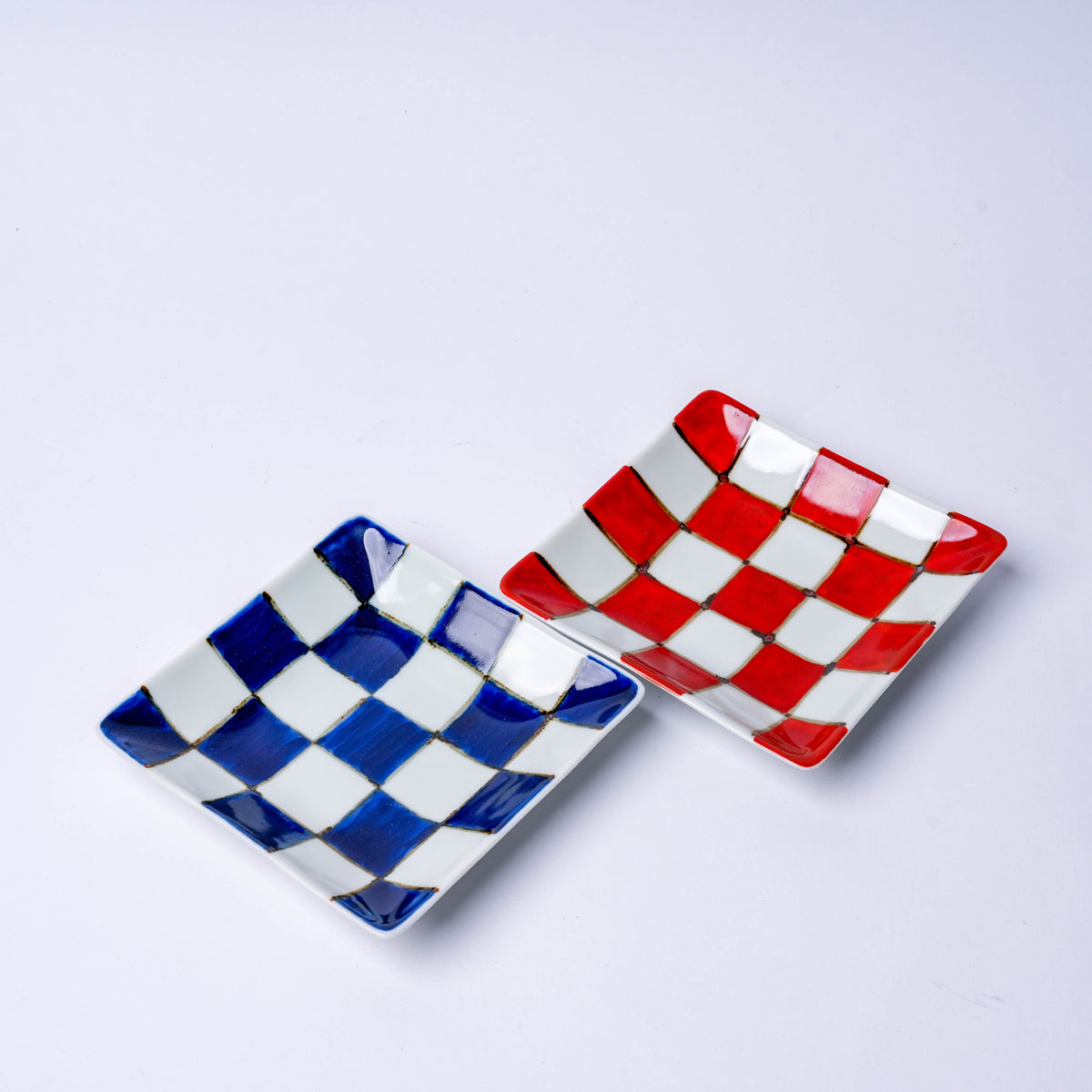 White square plate with blue and red checkered pattern, traditional Japanese porcelain design, perfect for serving appetizers or sweets